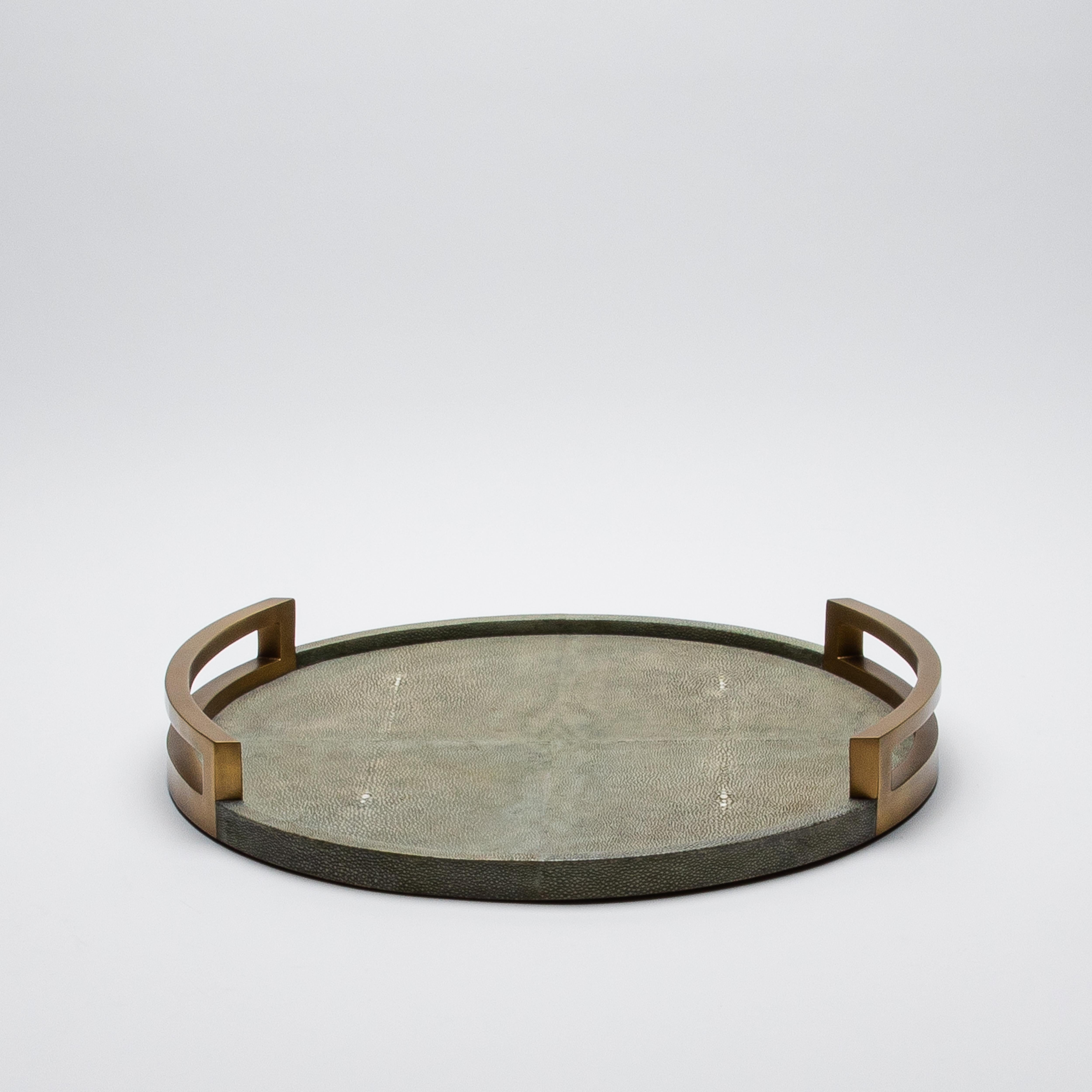 This round tray by R&Y Augousti is the epitome of opulence, where artistry and luxury converge in perfect harmony. The sumptuous grey shagreen surface, with its rich, textured allure, evokes an air of sophistication, while the gleaming bronze patina