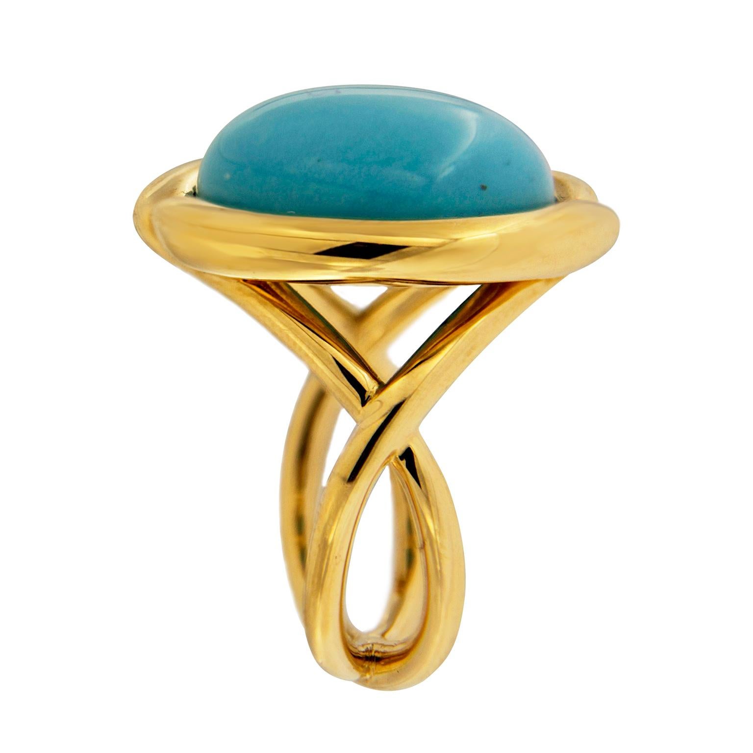 Turquoise takes center stage in this ring created by Valentin Magro. The jewel is carved into a round cabochon and polished smooth. It rests in an 18k yellow gold bezel setting with a subtle overlap motif. A gold double shank supports the stone.