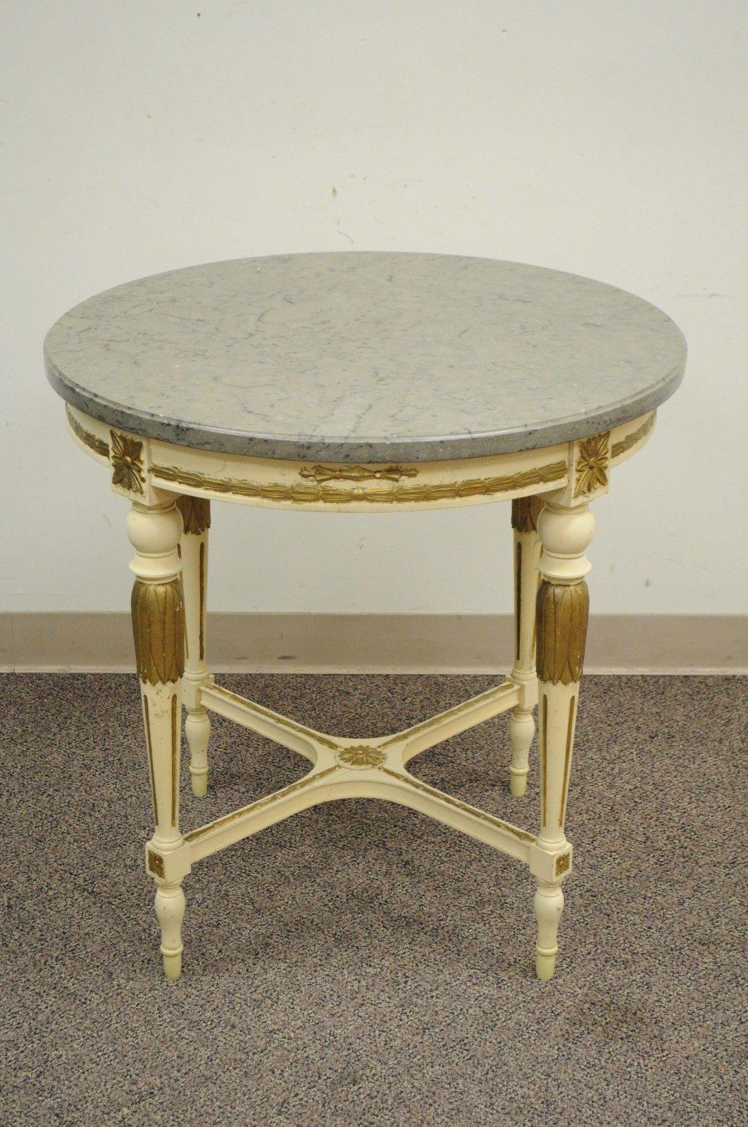 Vintage French Louis XV style round marble/granite top accent table. Item features solid wood frame, nicely carved details, cream and gold painted finish, tapered legs, stretcher base, grey stone top, very nice vintage item, great style and form,