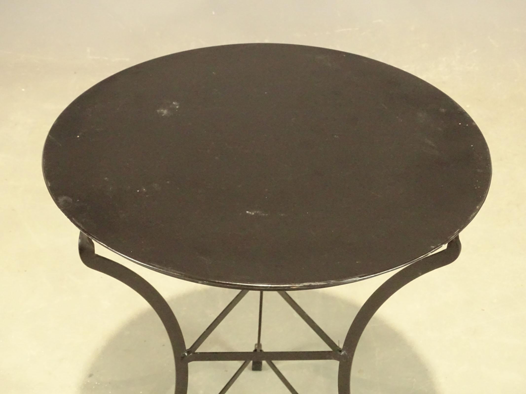 A fine vintage café or bistro table featuring a round or circular metal top, attached to a tripod base.
Great for an indoor or outdoor patio or garden use. Great for end or side table.
Decorative metal side table. Measures: 22 1/2