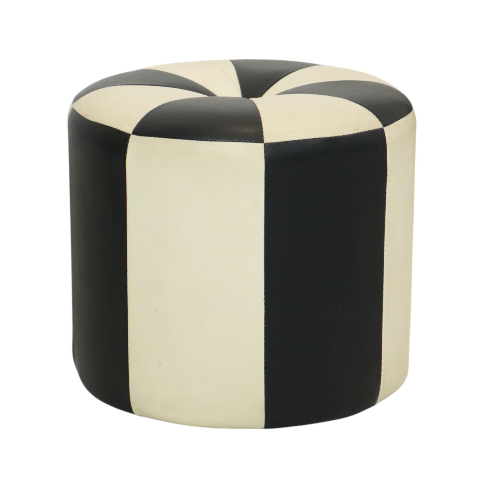 Cool vintage round patchwork-style ottoman, made from a wooden base and upholstered in high-quality two-tone black and white faux leather, manufactured in Belgium circa the 1960s.

A characterful and authentic piece from the 1960s, this ottoman