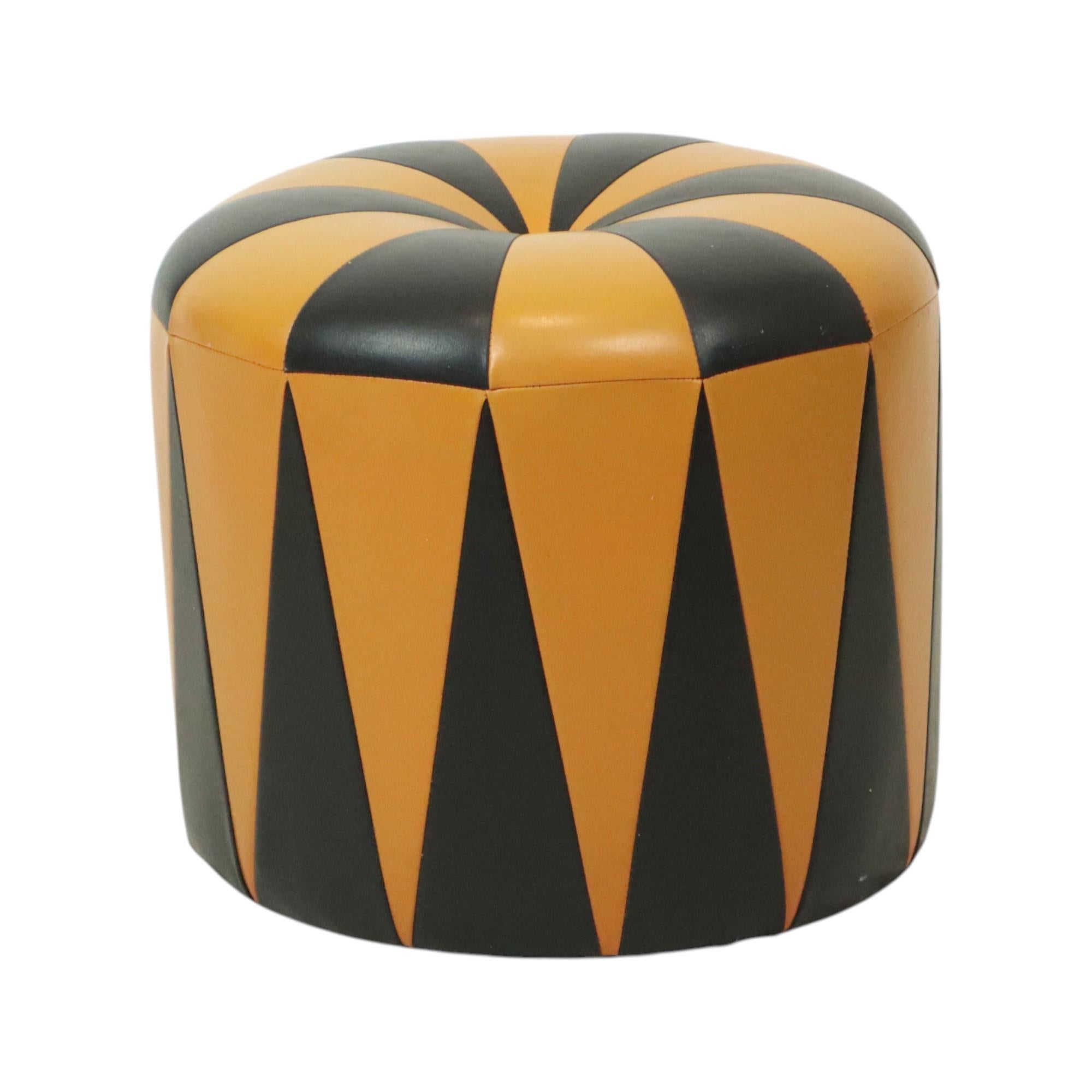 Cool vintage round ottoman in Moroccan patchwork style, made from a wooden base and upholstered in high-quality two-tone orange and black faux leather, made in Belgium circa the 1960s.

A characterful and authentic object from the 1960s, this