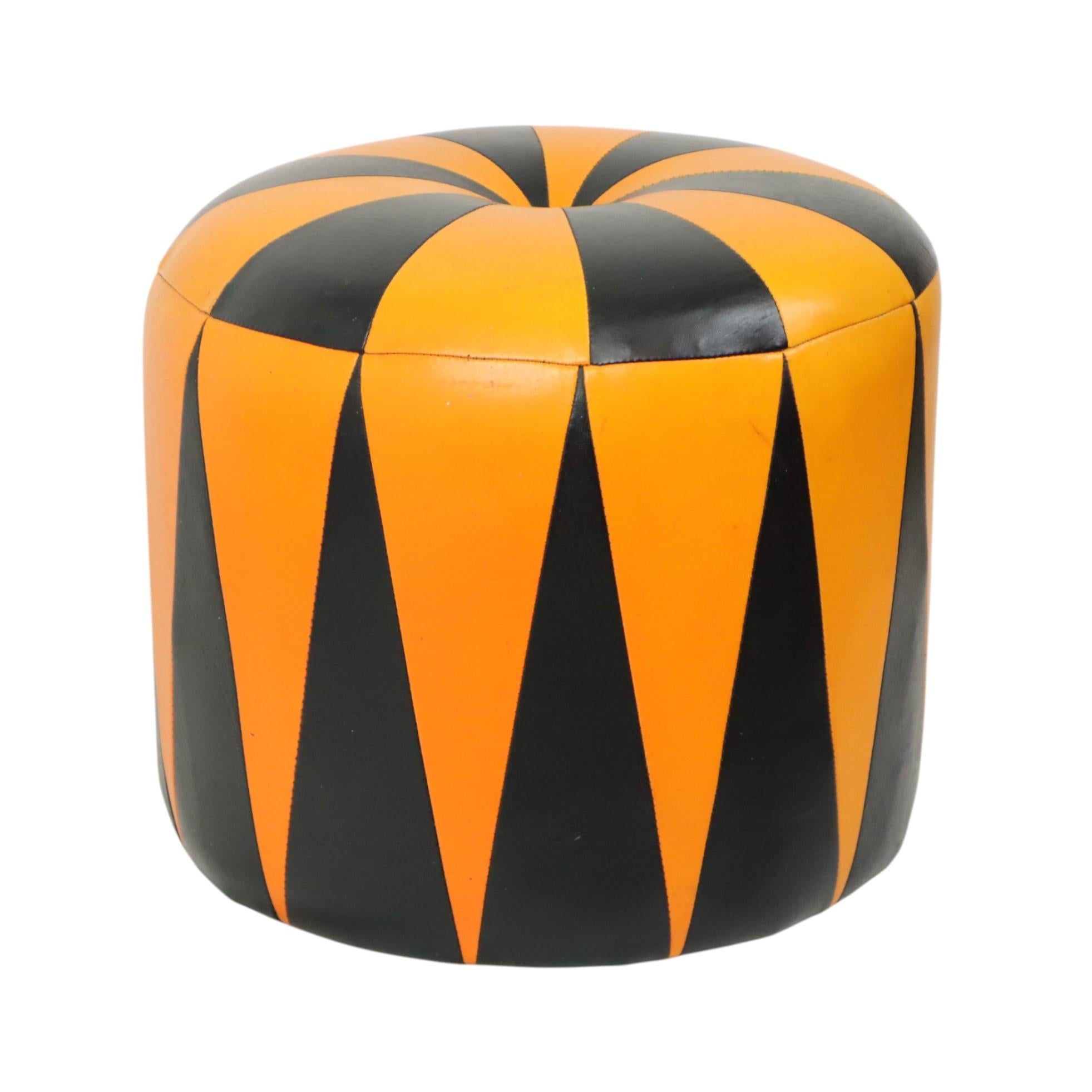 A very cool vintage round ottoman in a Moroccan patchwork style, made from a wooden base and upholstered in high-quality two-tone orange and black faux leather, made in Belgium circa the 1960s. Very rare in this color combination!

Charming and
