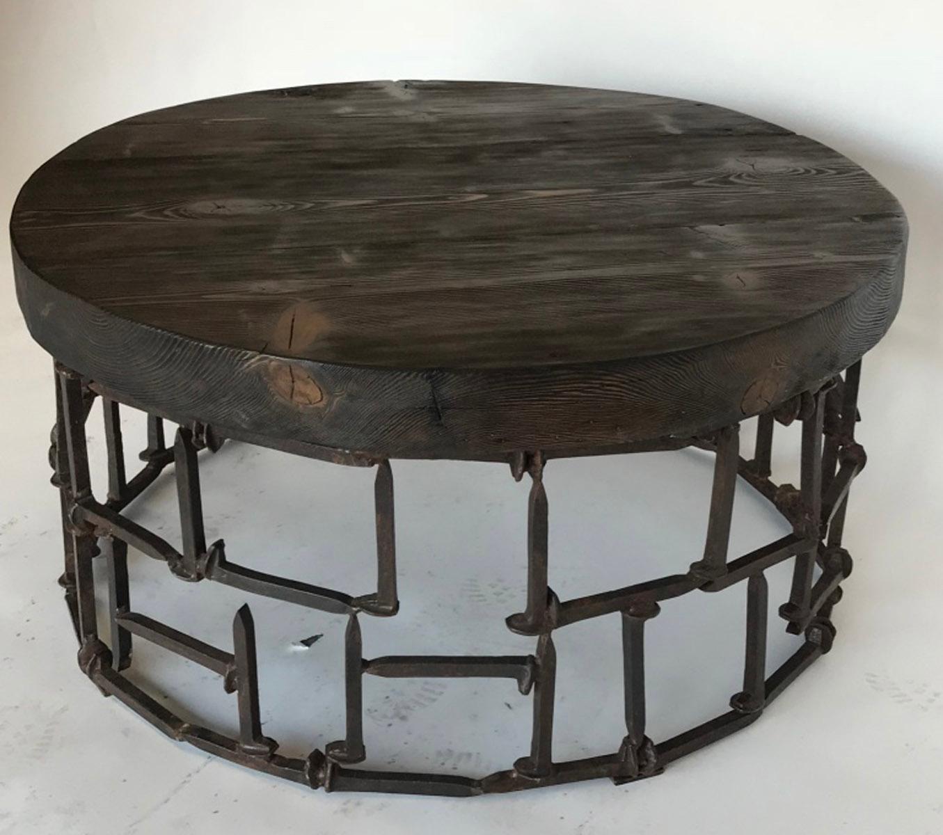 Custom  antique railroad spikes fashioned into a circular base with a 3.5 inch thick reclaimed wood top. Nails have natural sealed patina.
Made in Los Angeles. Can be made in custom sizes. Please inquire.