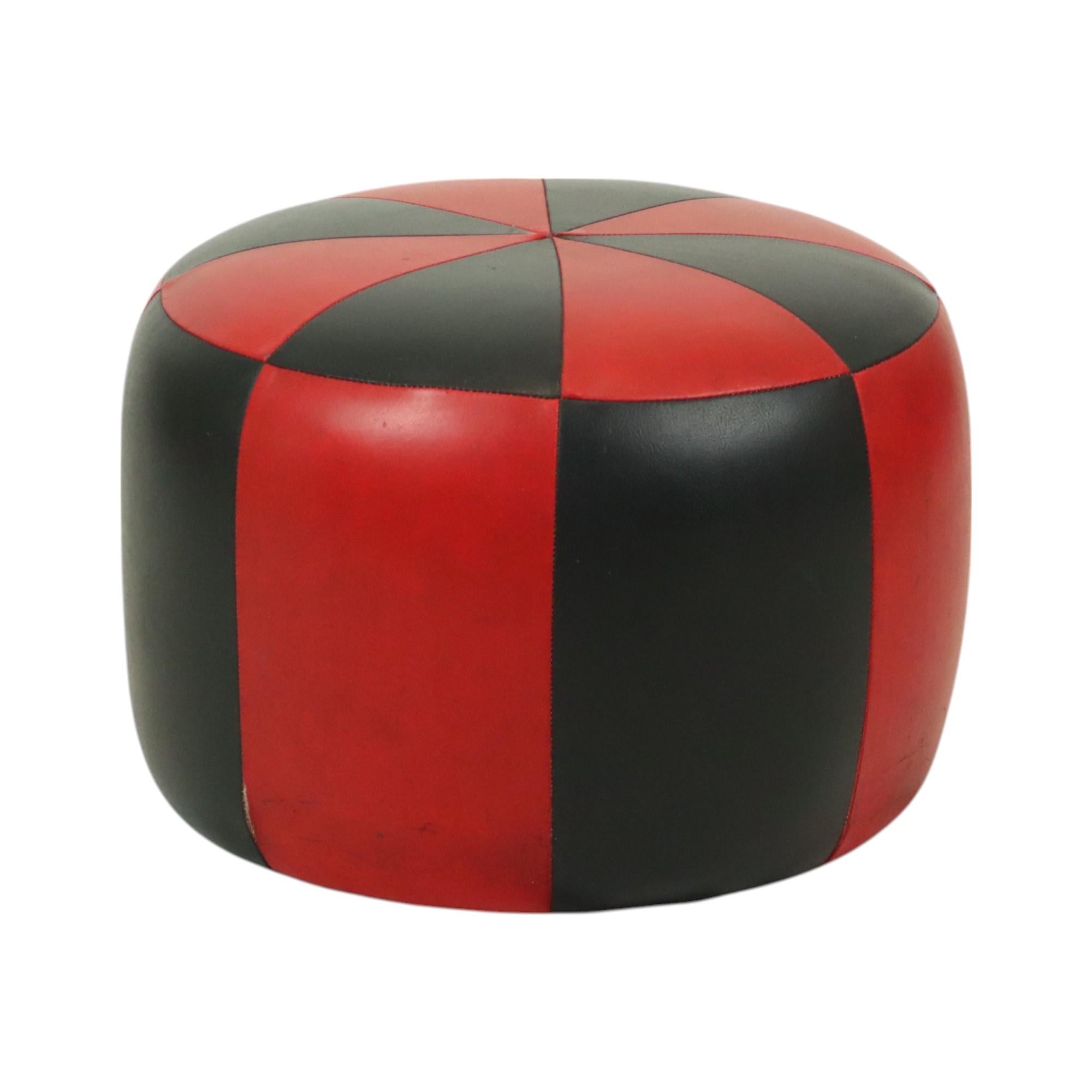 Cool round vintage patchwork ottoman, made from a wooden base and upholstered in high-quality two-tone red and black faux leather, made in Belgium circa the 1960s.

This ottoman is in good used vintage condition, with signs of wear and tear