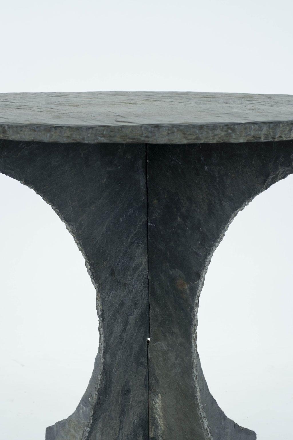 Round vintage slate side table from France, raised upon two-part shaped slate base.