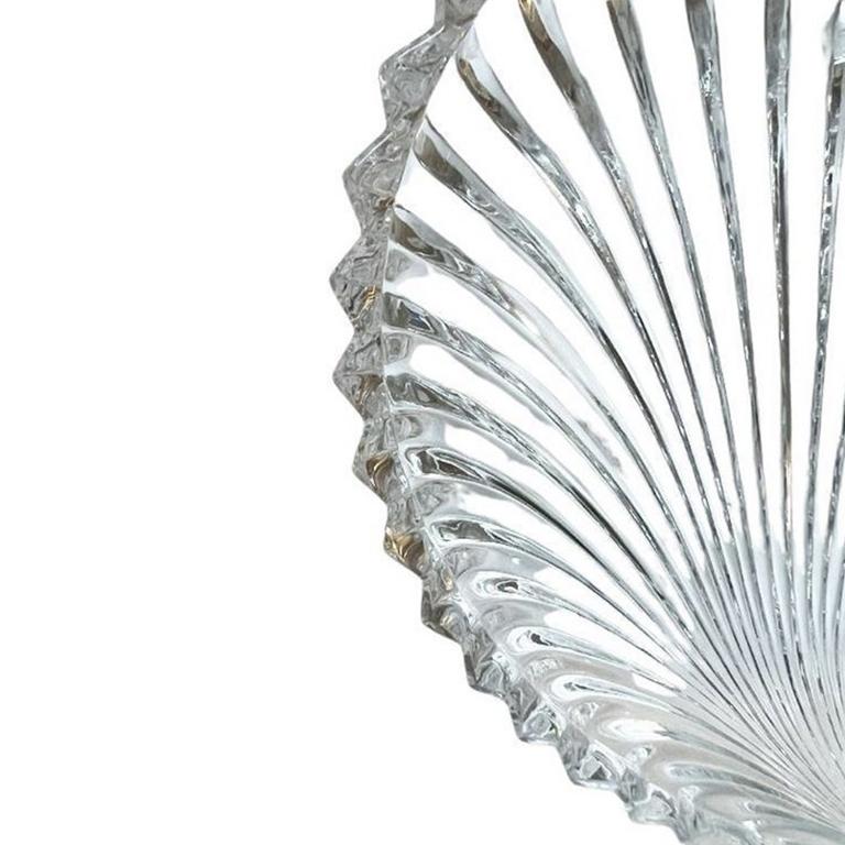A round scalloped crystal glass trinket dish by Villeroy & Boch. This heavy piece will be lovely on a side table, nightstand, dressing table or coffee table. It is round, with scalloped edges and a smooth interior. The exterior is textured and
