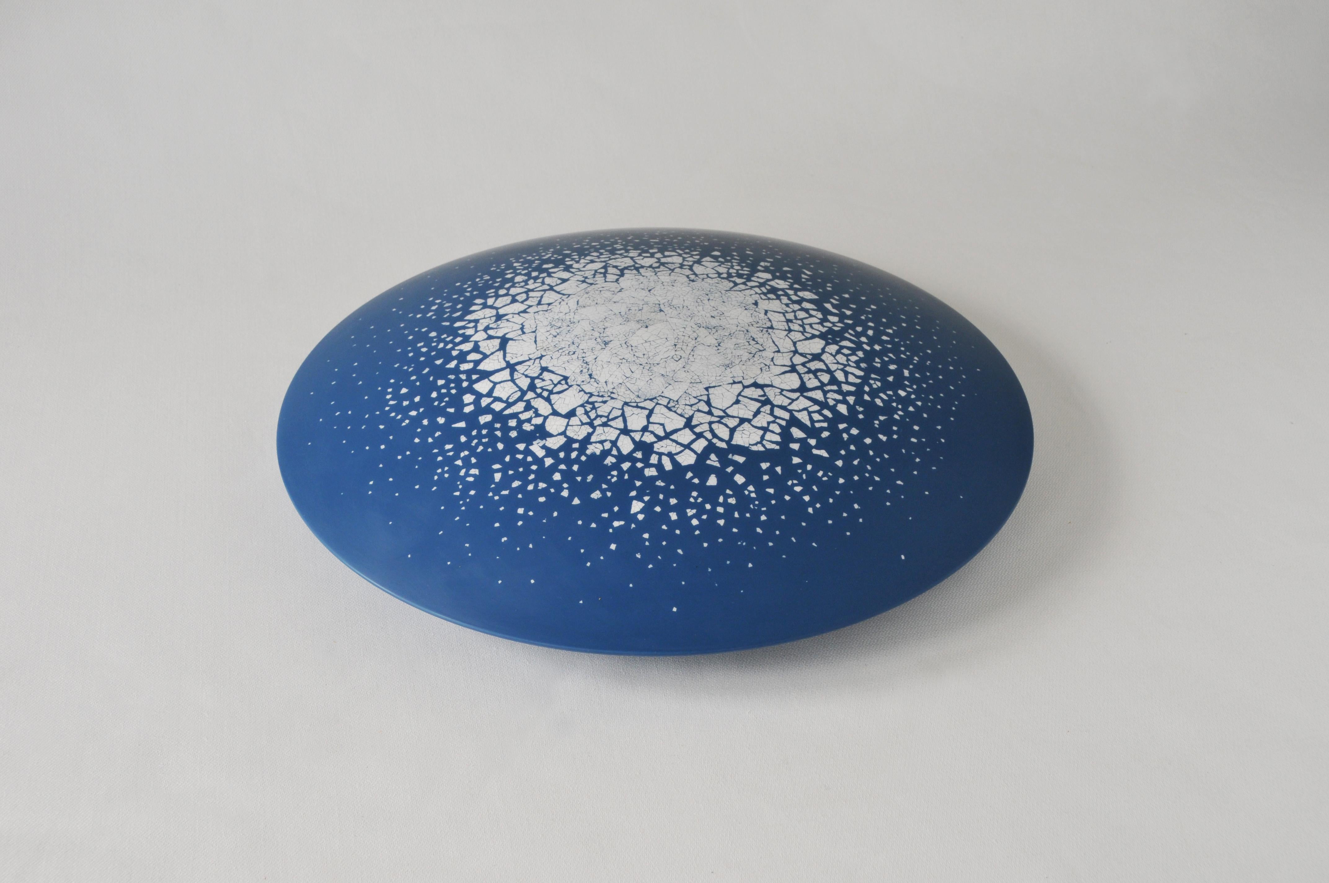 Round wall art sculpture of lacquered pearwood and eggshell. Minute pieces of eggshell, meticulously placed, appear to float like icebergs in intensely blue arctic waters. Influenced by early 20th century masters such as Majorelle, Gallé, the artist