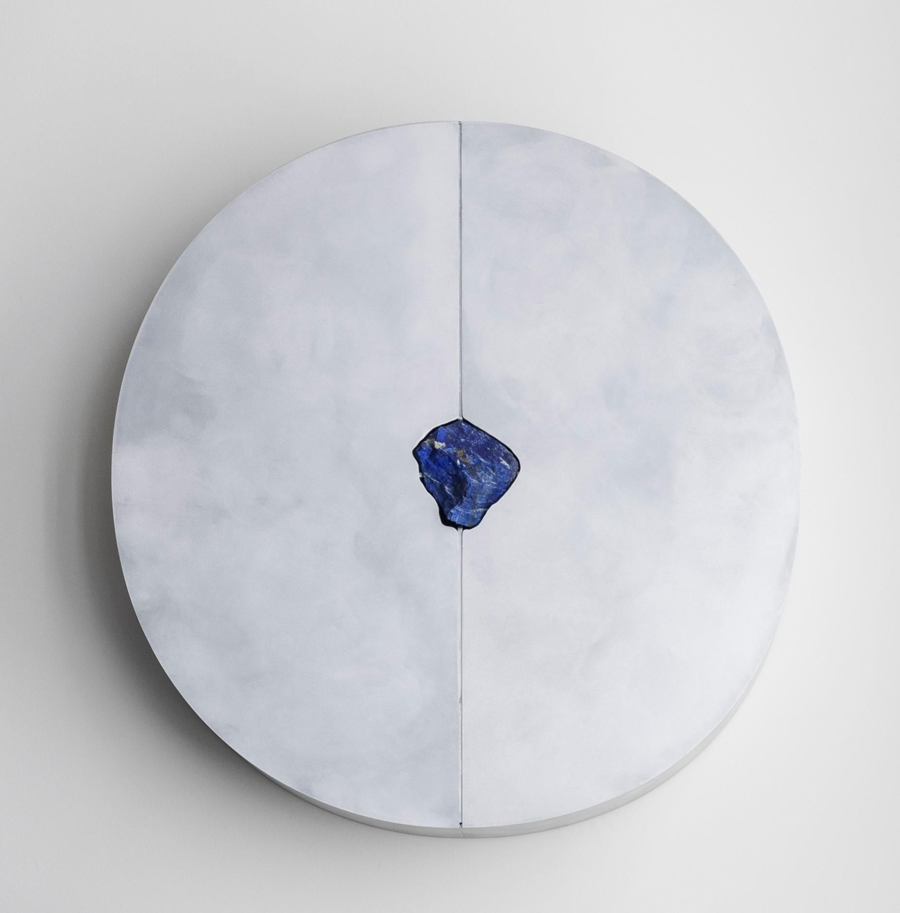 Round wall cabinet with lapis lazuli by Pierre De Valck.
Dimensions: W 90 x D 15 x H 90 cm.
Materials: Waxed aluminium with Lapis Lazuli.
Weight: 45 kg.
Each piece is unique.

Pierre De Valck (1991) born in Brussels, is a Ghent-based designer