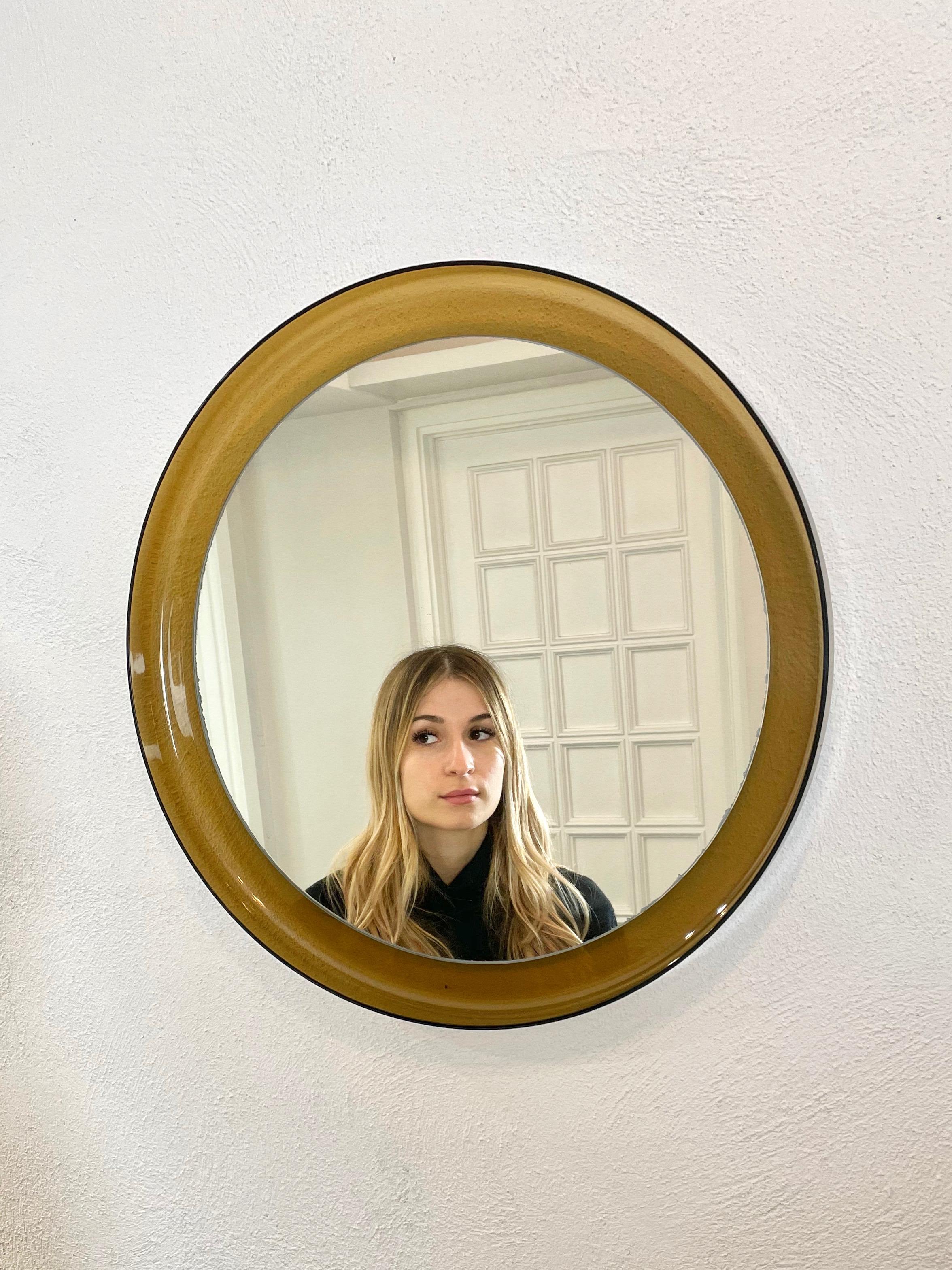 Round wall mirror featuring a yellow Lucite frame in the style of Guzzini. Made in Italy in the 1960s.
