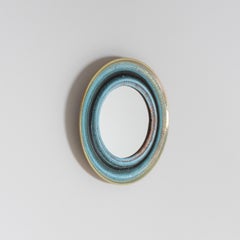 Round wall mirror with ceramic frame