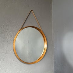 Round wall mirror with light teak frame, leather hook for posting 1960 Italian