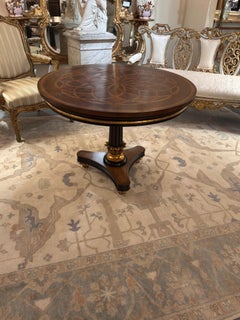 Round walnut center table with marquetry top and gilt accents