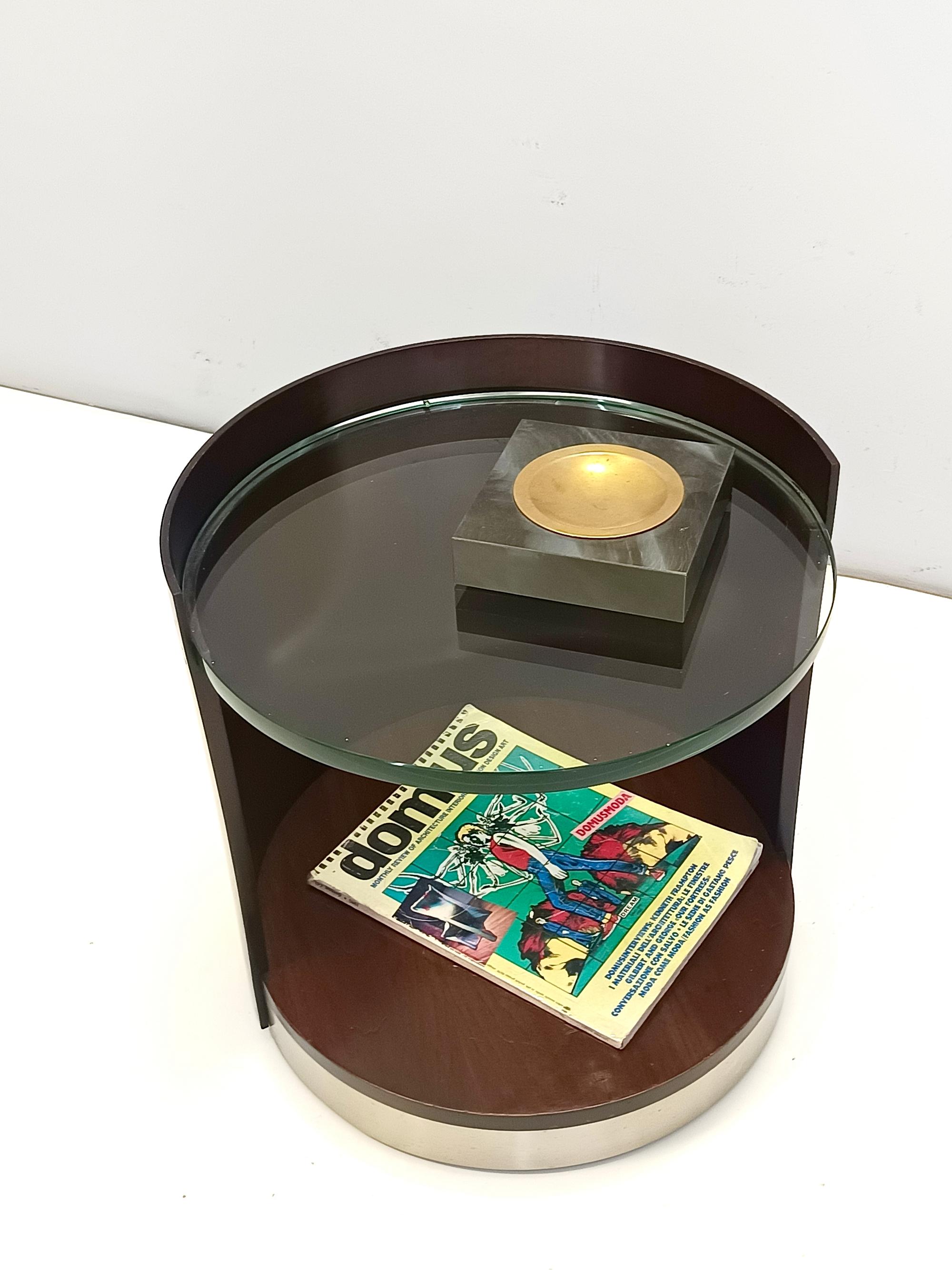 Made in Italy, 1970s. 
This coffee table features a multi-layered curved walnut frame with a 2-cm thick glass shelf and a satined steel band. 
It features casters. 
This is a vintage piece, therefore it might show slight traces of use, but it can be