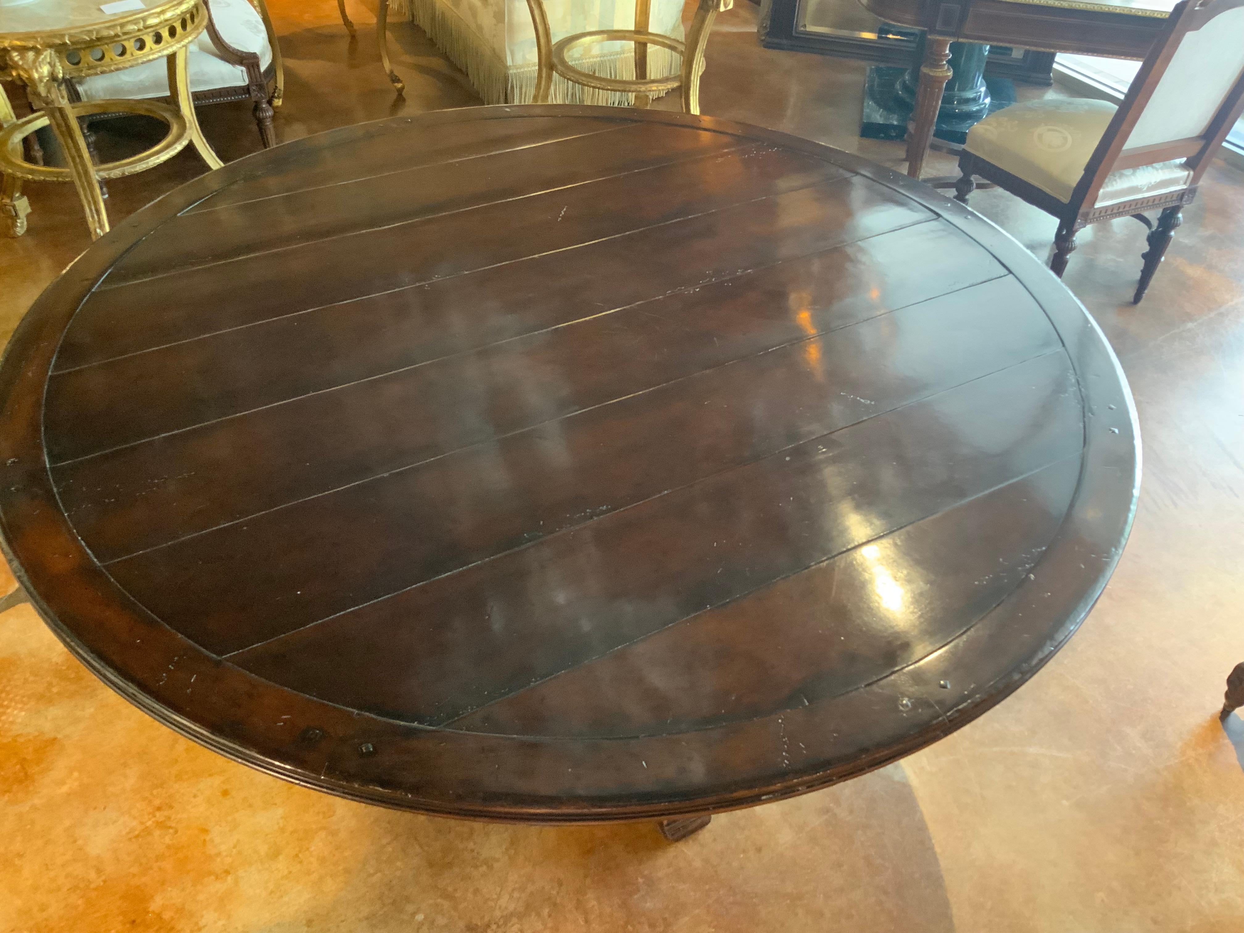 Contemporary Round walnut dining table on a pedestal Four post carved leg, 60” diameter 