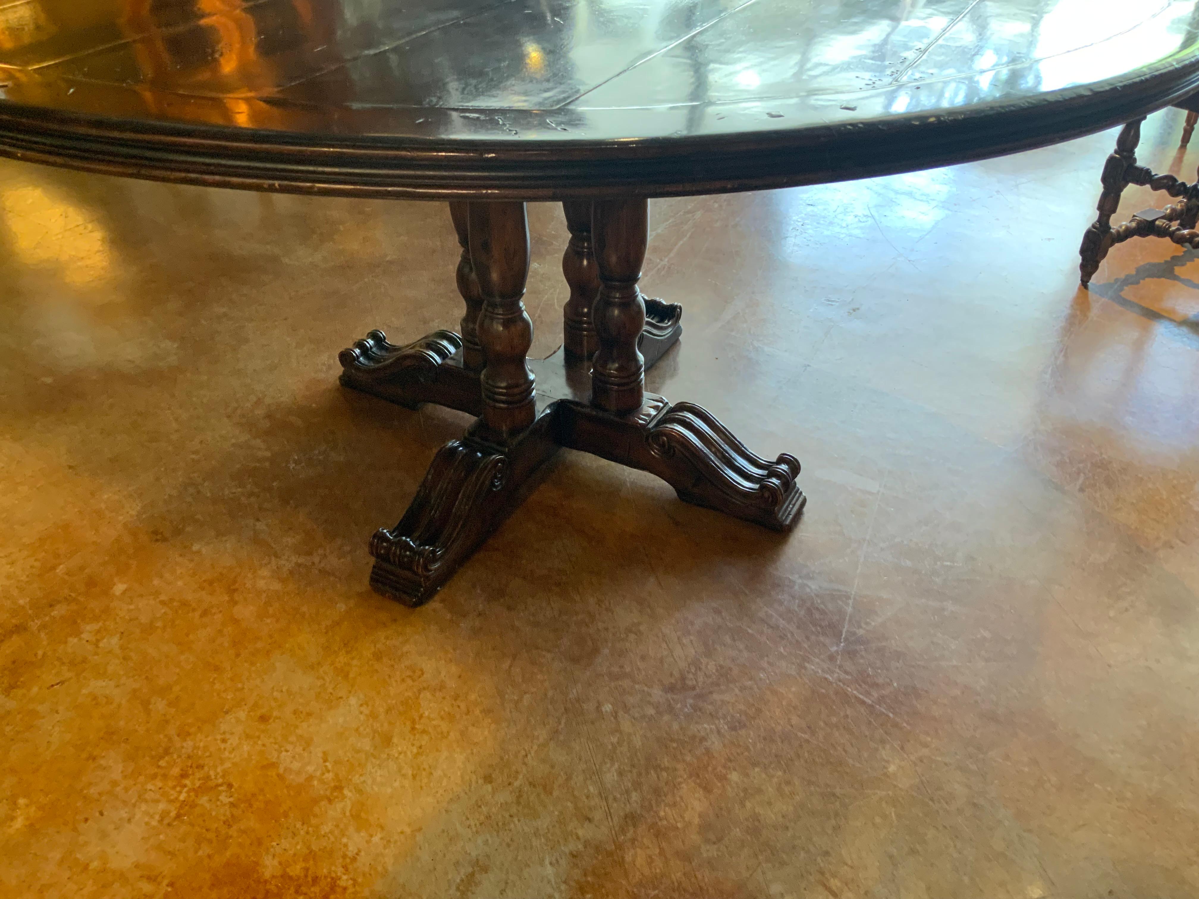 Walnut Round walnut dining table on a pedestal Four post carved leg, 60” diameter 