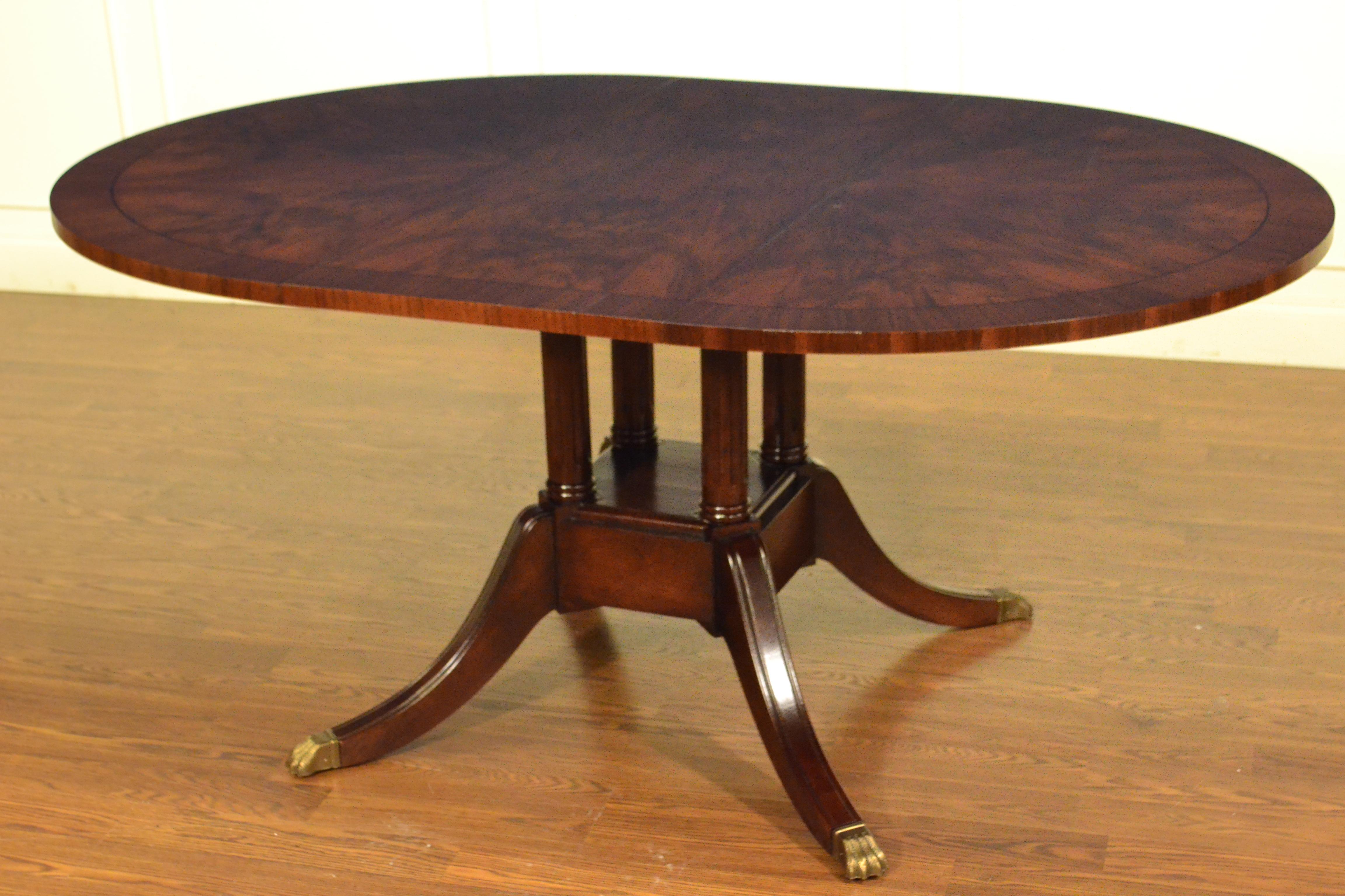 This is made-to-order round traditional walnut dining table made in the Leighton Hall shop. It features field of radial cut cathedral walnut and a border of straight grain walnut. There is an ebony inlay line that separates the field from the