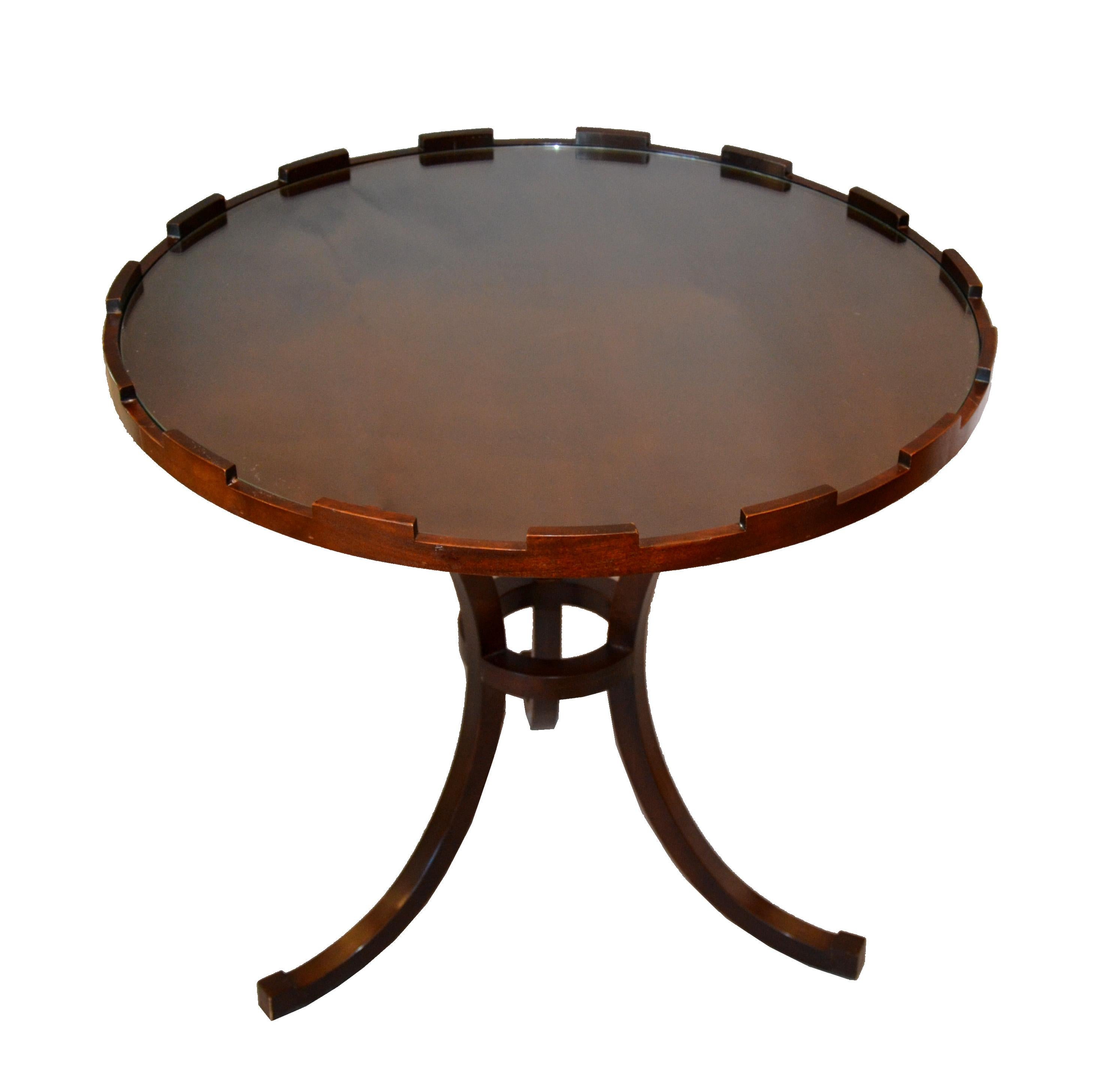 Round walnut side table with glass top by baker.
The baker metal tag is attached under the top.
Can be used as a side or as a cocktail table.