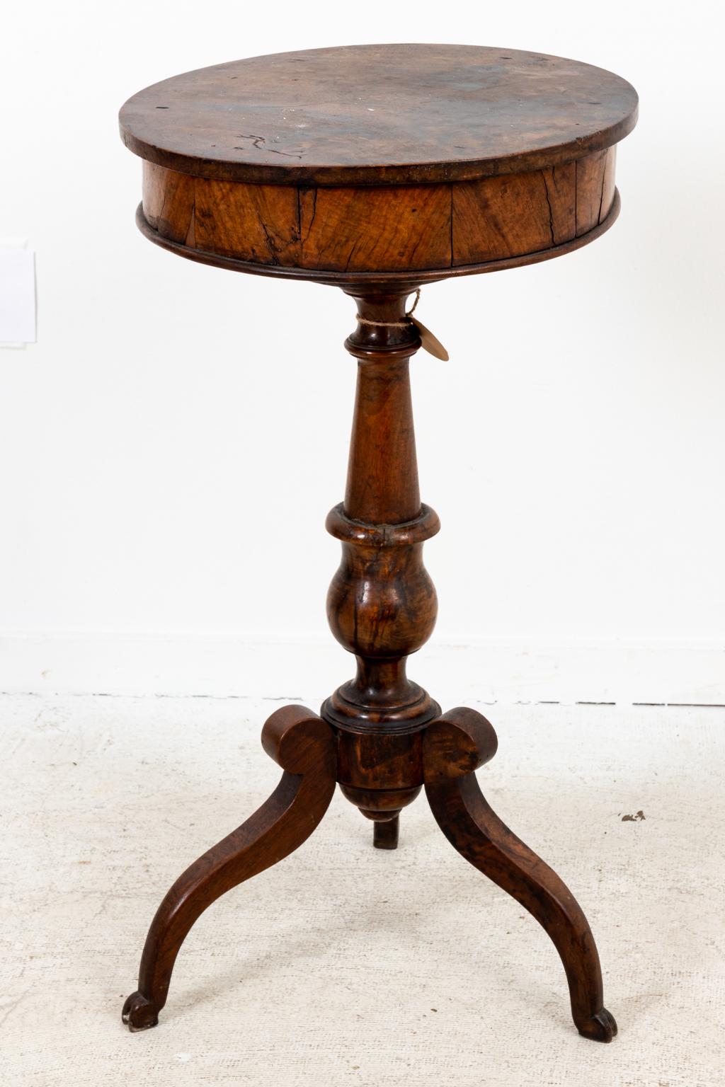 Circa 1830s continental round walnut work table on stand in the French Directoire style. Please note of wear consistent with age.