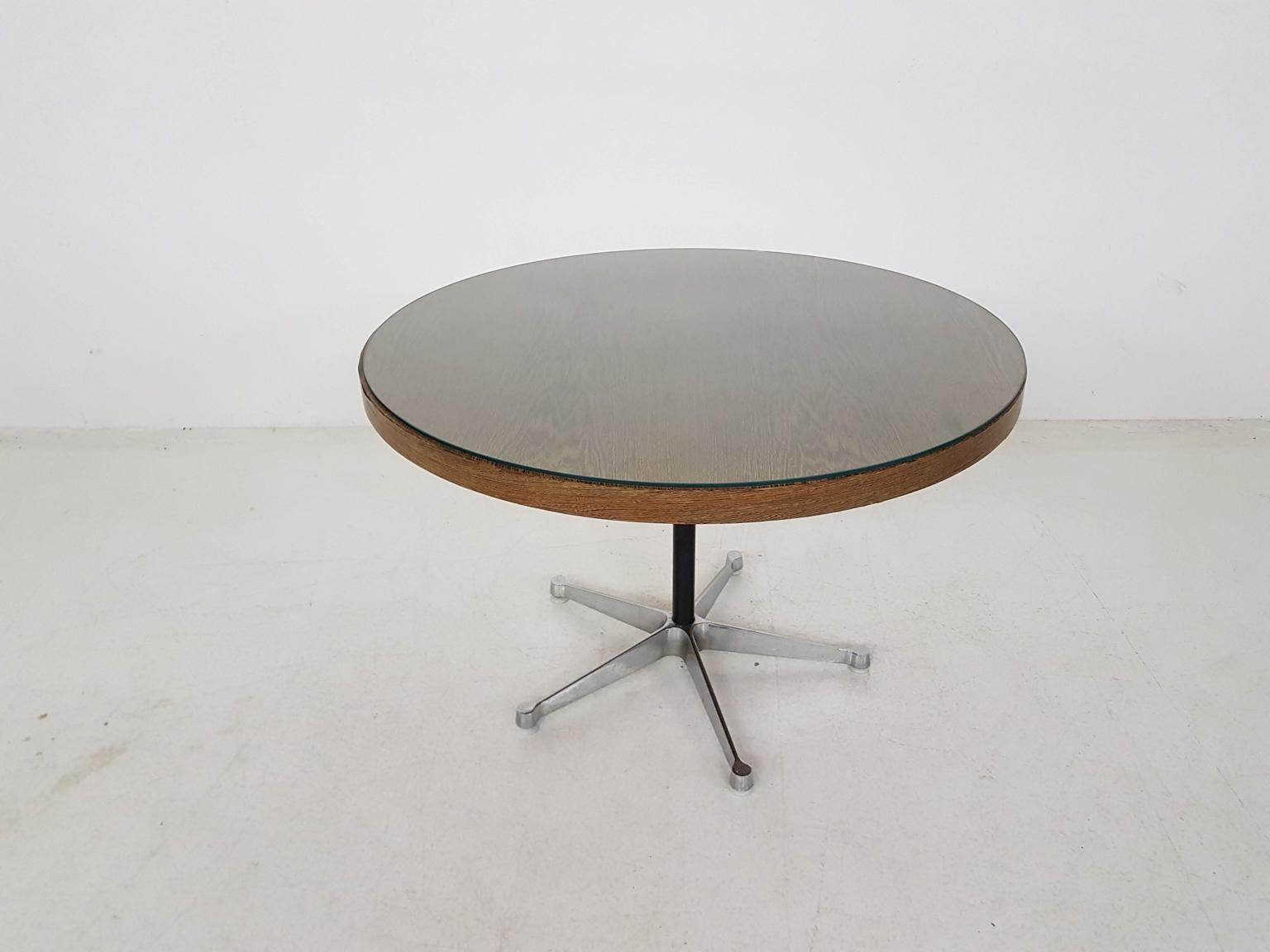 Round wenge veneer top and a metal foot.
Glass top was used to protect the table, it has a small chip, but the table can also be used without the glass top.