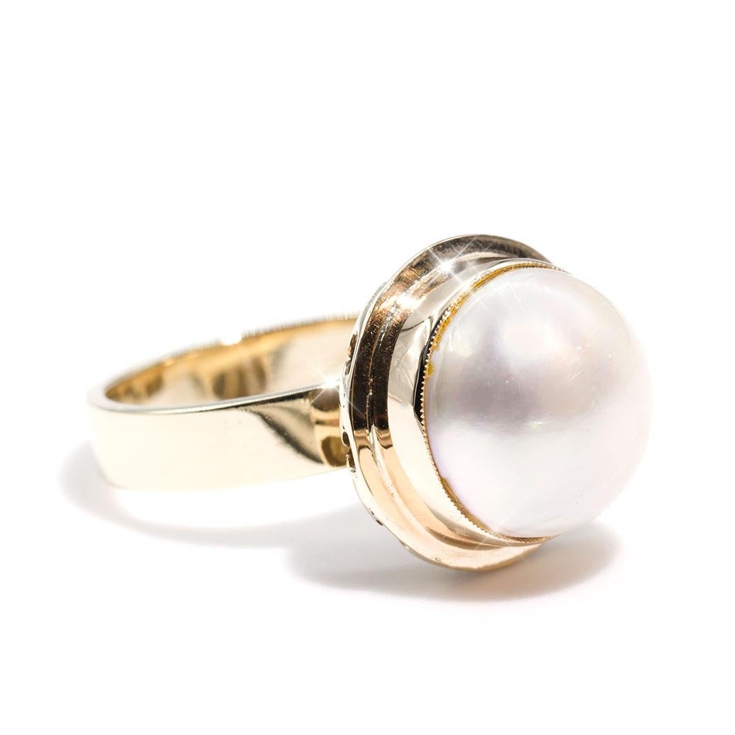 Forged in 9 carat yellow gold is this darling vintage ring featuring a central white round 12 millimetre Mabe pearl carefully set in an intricate gallery. The Alex Ring is a heart warming design that transitions easily from day into evening, making