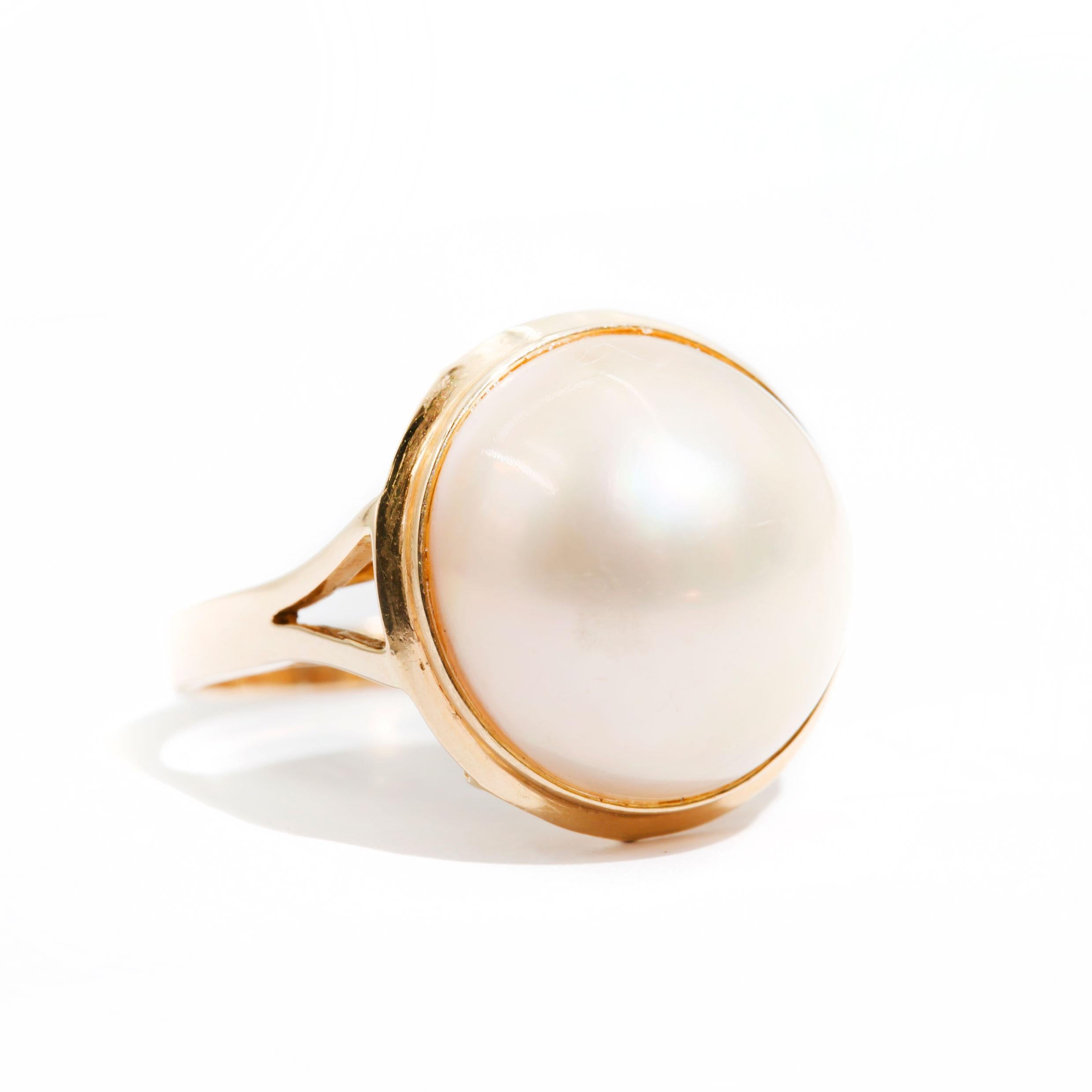 Forged in 9 carat yellow gold is this darling vintage ring featuring a central white round 14 millimetre Mabe pearl carefully set in an intricate basket. The Emma Ring is a heart warming design that transitions easily from day into evening, making