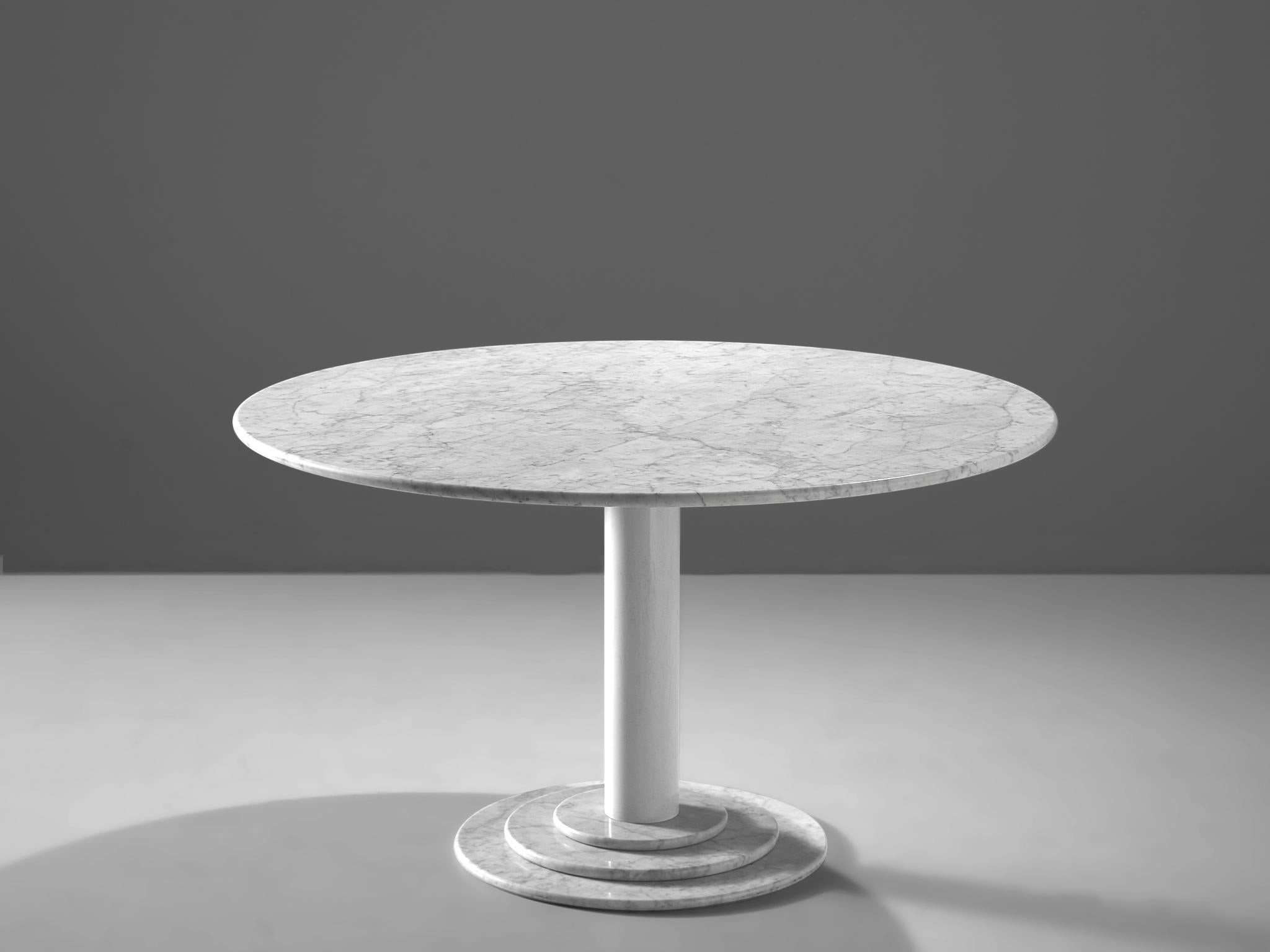 Round dining table, white marble, Italy, 1970s

This table is a skillful example of Postmodern design. A white lacquered metal pedestal with a marble foot holds a minimalistic marble tabletop. A great Classic designed in the style of Acerbis. The