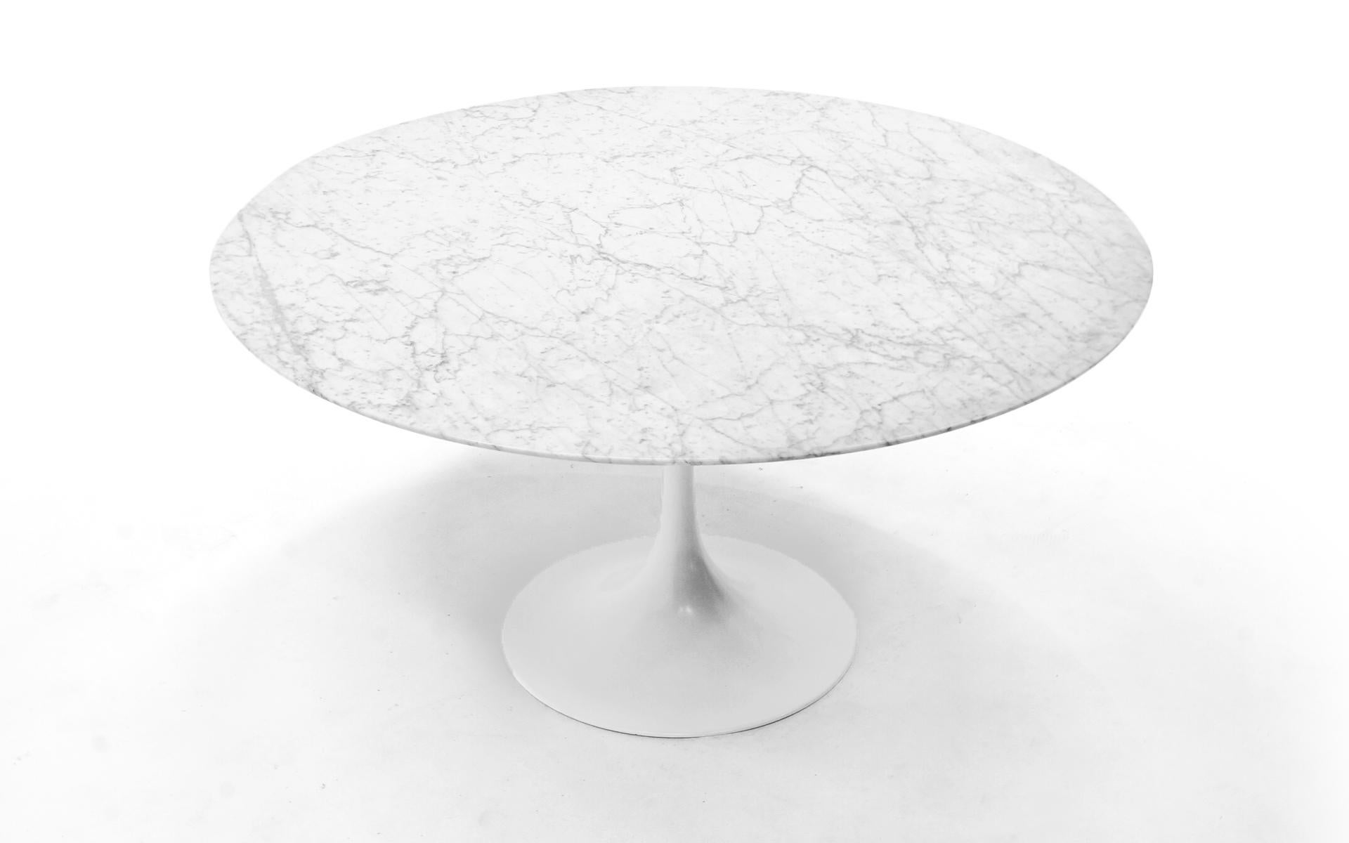 54 inch round white marble dining table designed by Eero Saarinen for Knoll. We acquired this example from a retired prominent Kansas City architect who originally purchased it new in London in the 1980s. Very good condition with few signs of light
