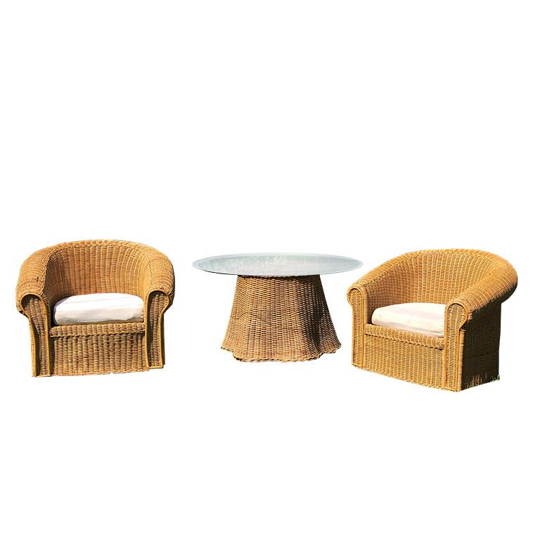 1970s round sculptural handcrafted Trompe L'oeil rattan draped-sheet or ghost table and matching chair set. The table is handwoven in warm honey-colored wicker and is meant to fool the eye with the illusion of a skirted table. The bottom of the
