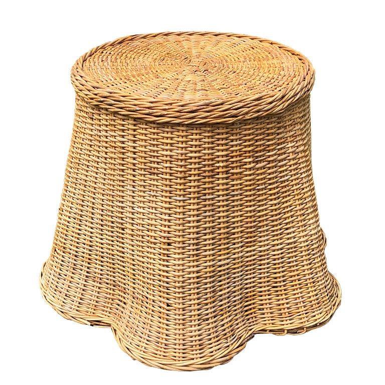 1970s round sculptural handcrafted Trompe L'oeil rattan draped-sheet or ghost table. The table is handwoven in warm honey-colored wicker and is meant to fool the eye with the illusion of a skirted table. The bottom of the pedestal table base is wavy