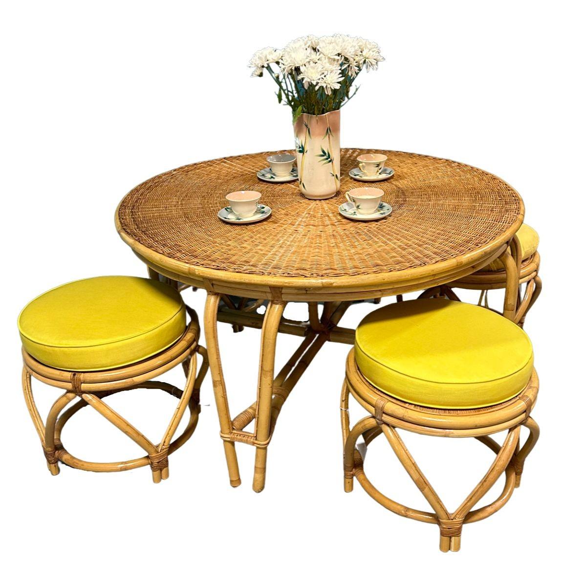 This beautifully restored Frankl style mid-century rattan dining set features four dining chairs and a dining table. This minimal yet elegant dining table and chair set features a steam-pressed sculptural form with a round glass top for the table.