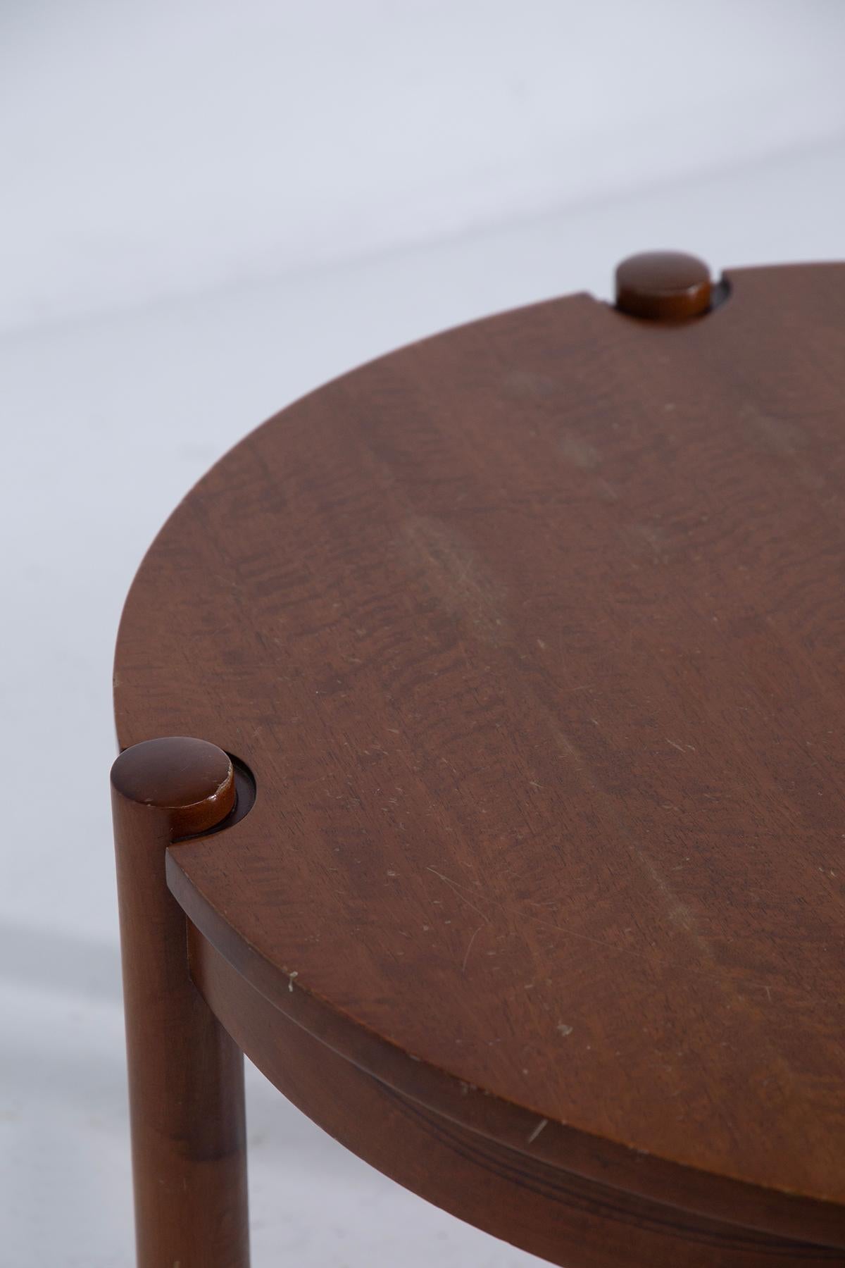Discover the timeless elegance of mid-century Italian craftsmanship with this round wooden coffee table designed by Osvaldo Borsani in the 1950s-60s. Known for his innovative approach, Borsani's designs remain highly sought after by collectors and