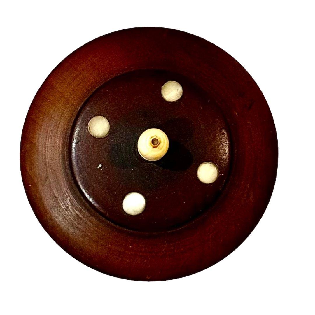 A round wooden box from India. Might be some type of rosewood. Circa 1920s, maybe a little earlier. Box with ivory feet and finial. The interior is about two inches deep.