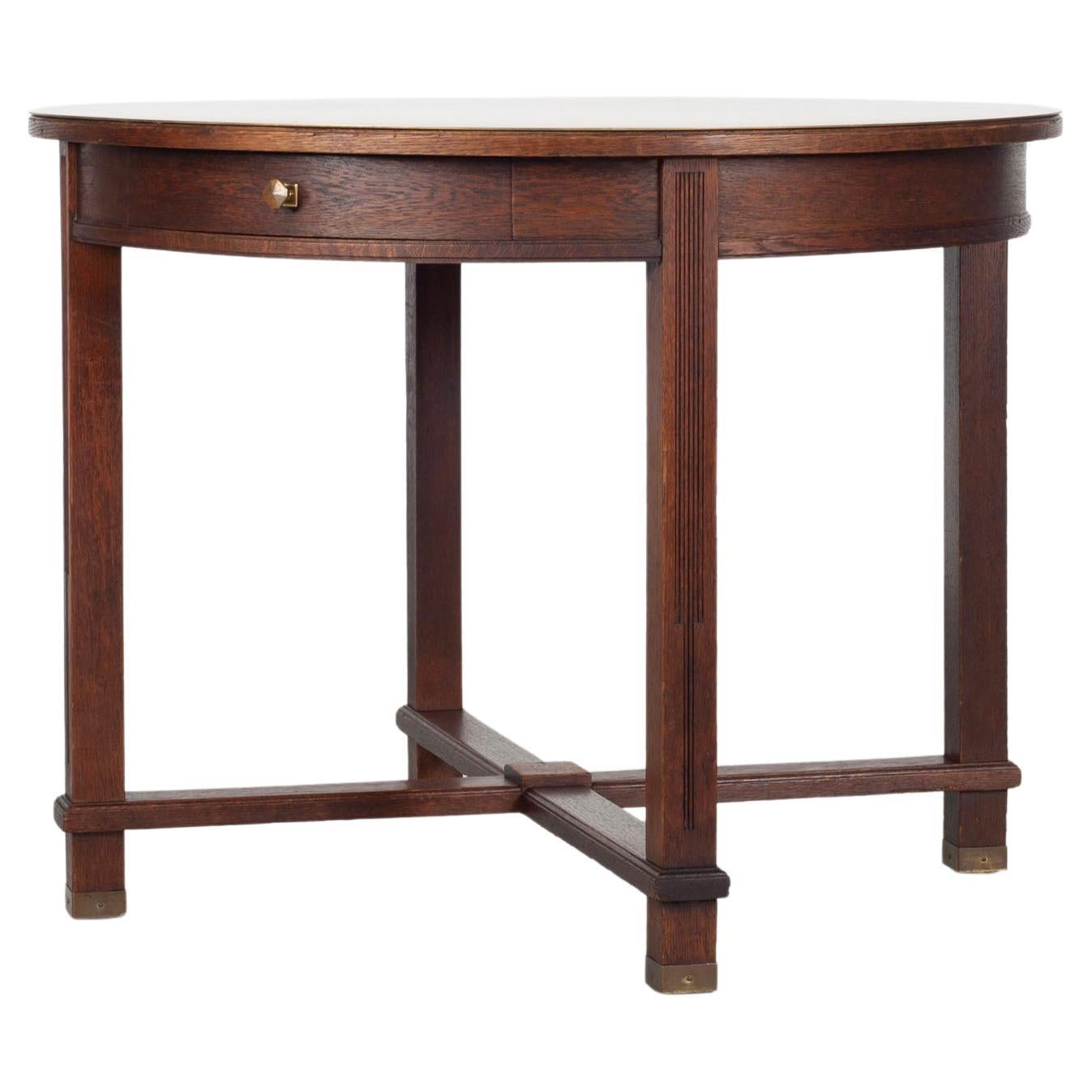 Round wooden table with brass tabletop from the 1920s. For Sale