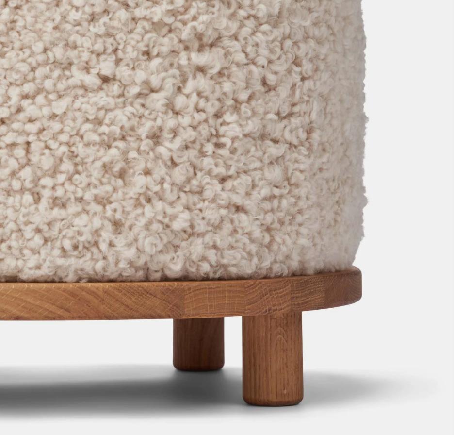 Round wool stool with walnut base. Pull up a seat when you need extra.