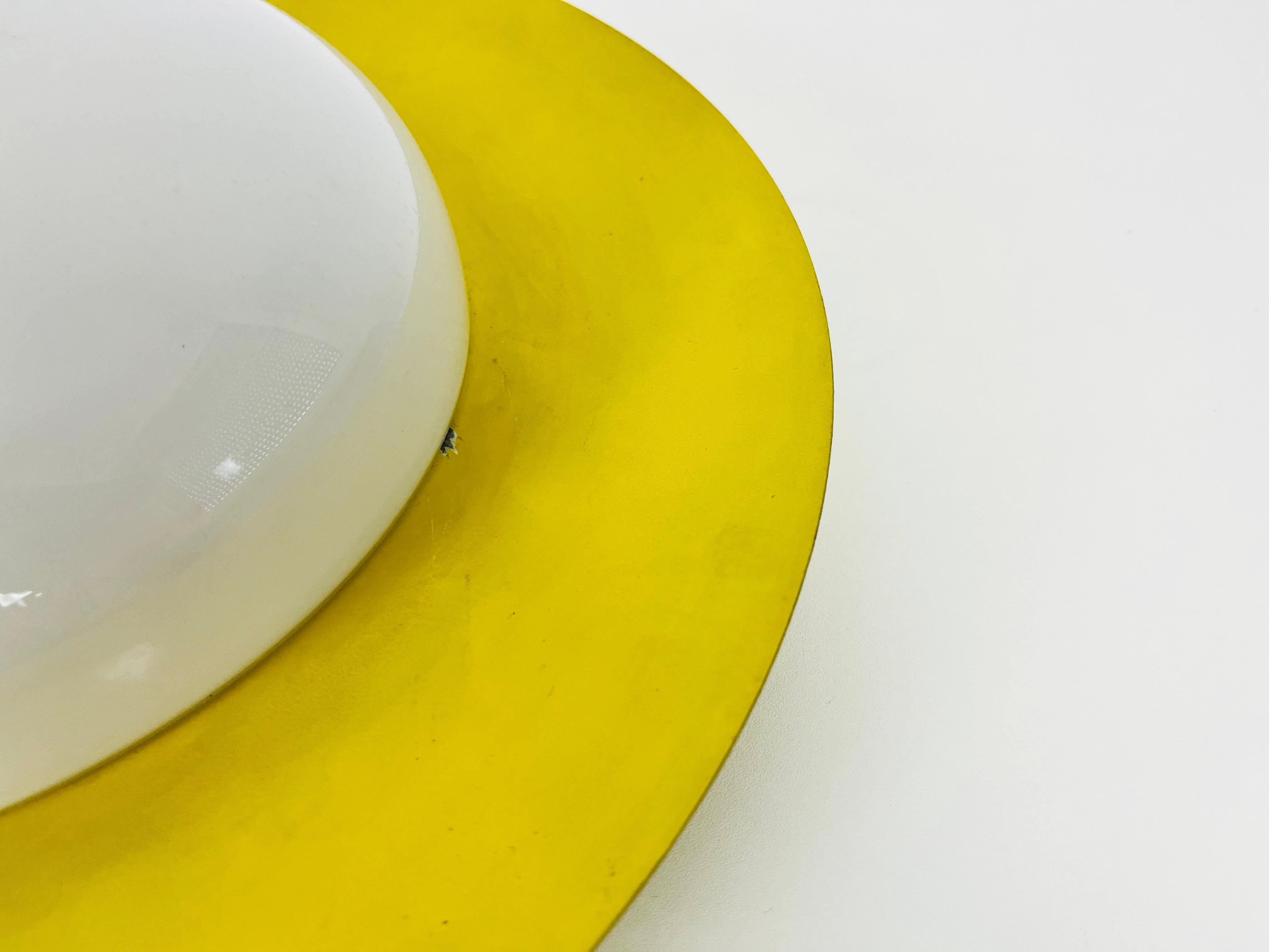 German Round Yellow Midcentury Metal and Opaline Glass Flushmount by Kaiser, 1960s For Sale