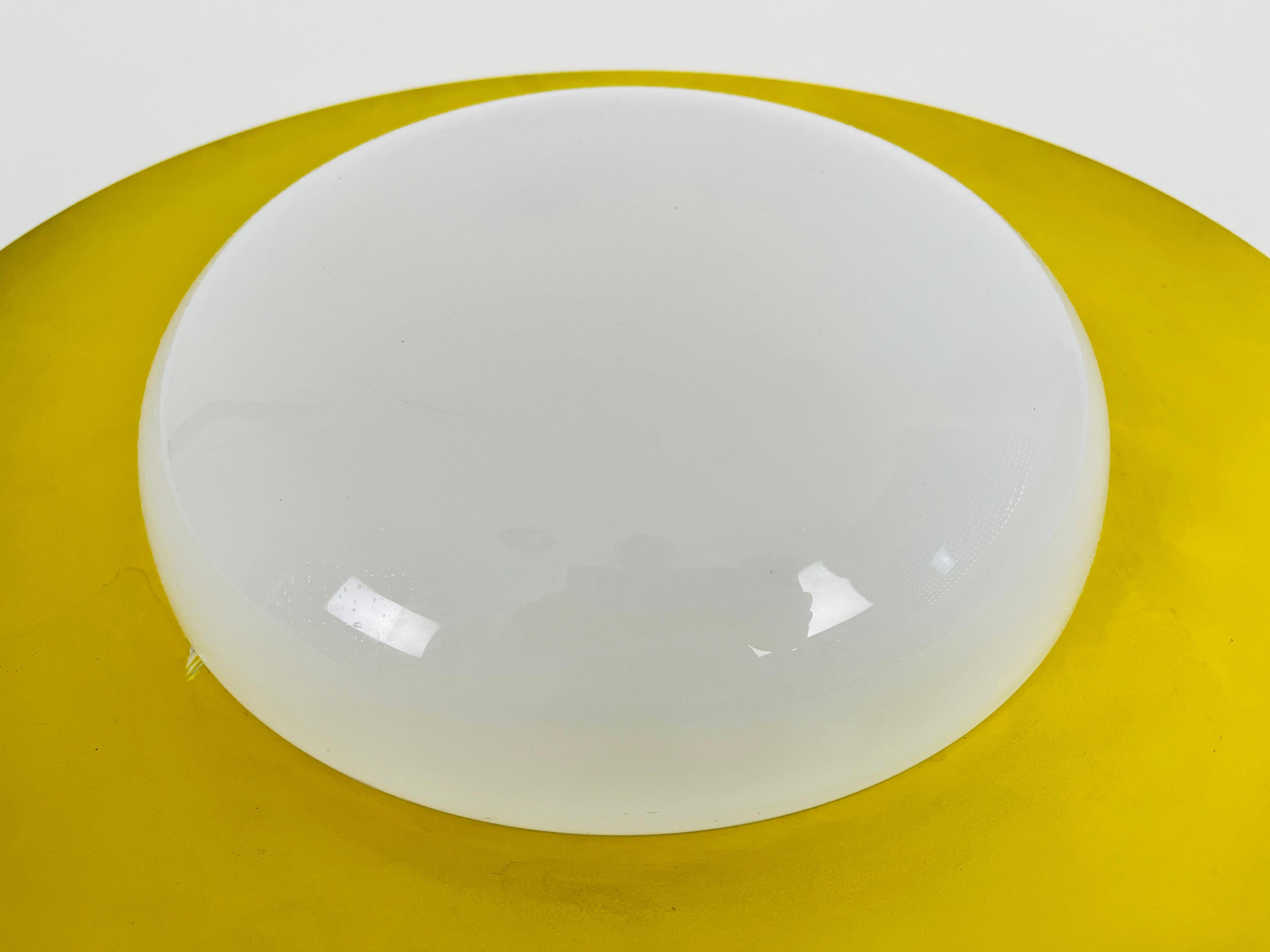 Round Yellow Midcentury Metal and Opaline Glass Flushmount by Kaiser, 1960s In Good Condition For Sale In Hagenbach, DE