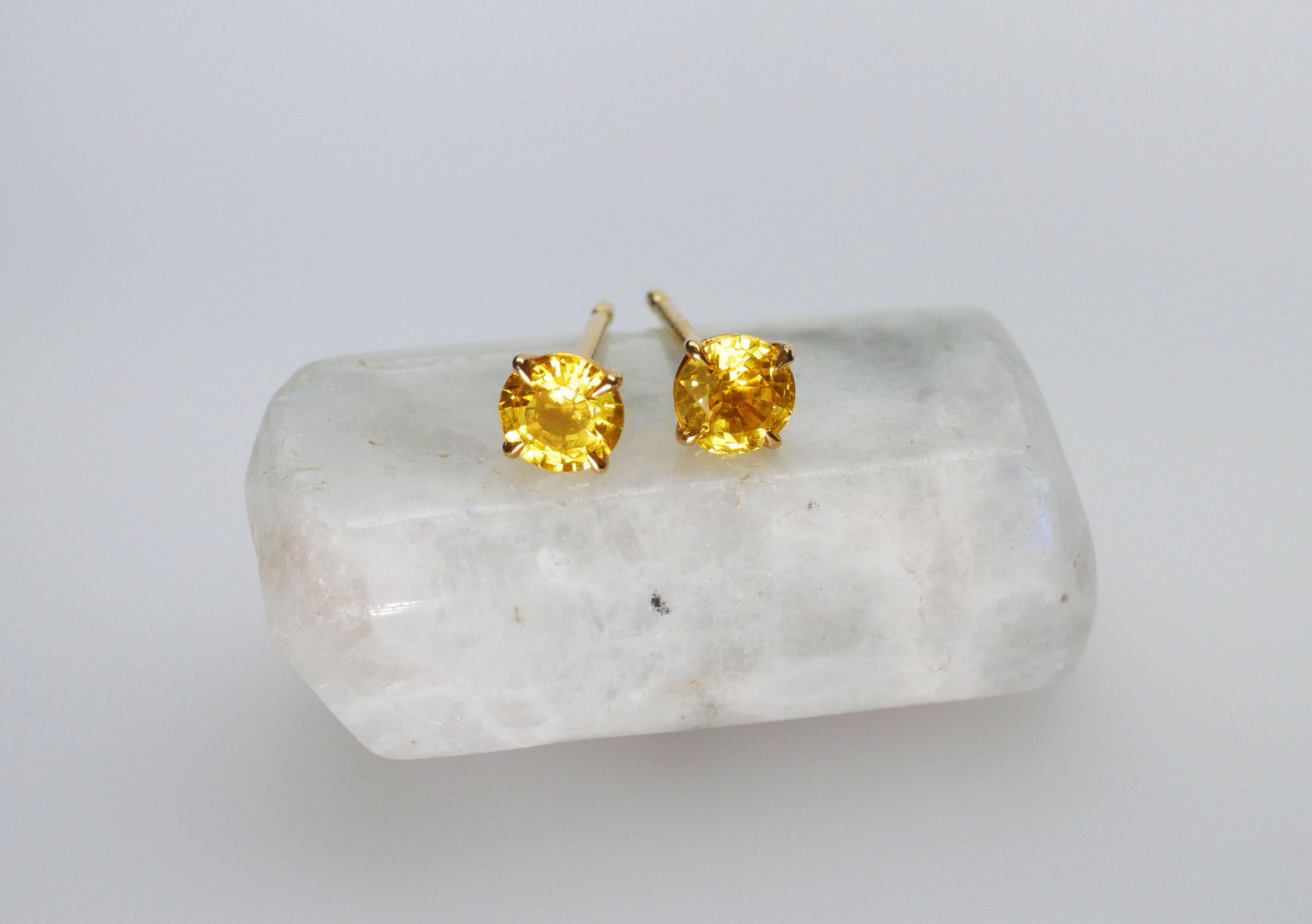 Hand made solitaire warm yellow round sapphire stud earrings in 18k yellow gold. Minimal and elegant with talon-shaped claws and an open basket setting,  to put on and never take off.

Total Yellow Sapphire Weight 2/1.10 Carat.