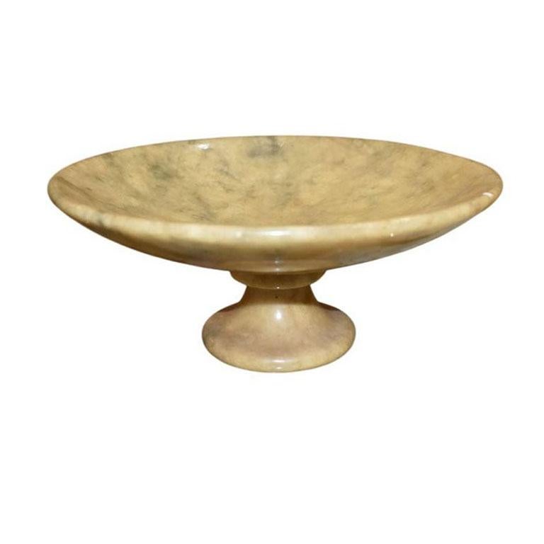 A beautiful carved Italian circular yellow stone fruit bowl that sits upon a round pedestal base. With gorgeous veining in pale yellow, greens, and whites, this piece will add the subtle vintage detail that each room deserves. This piece would be