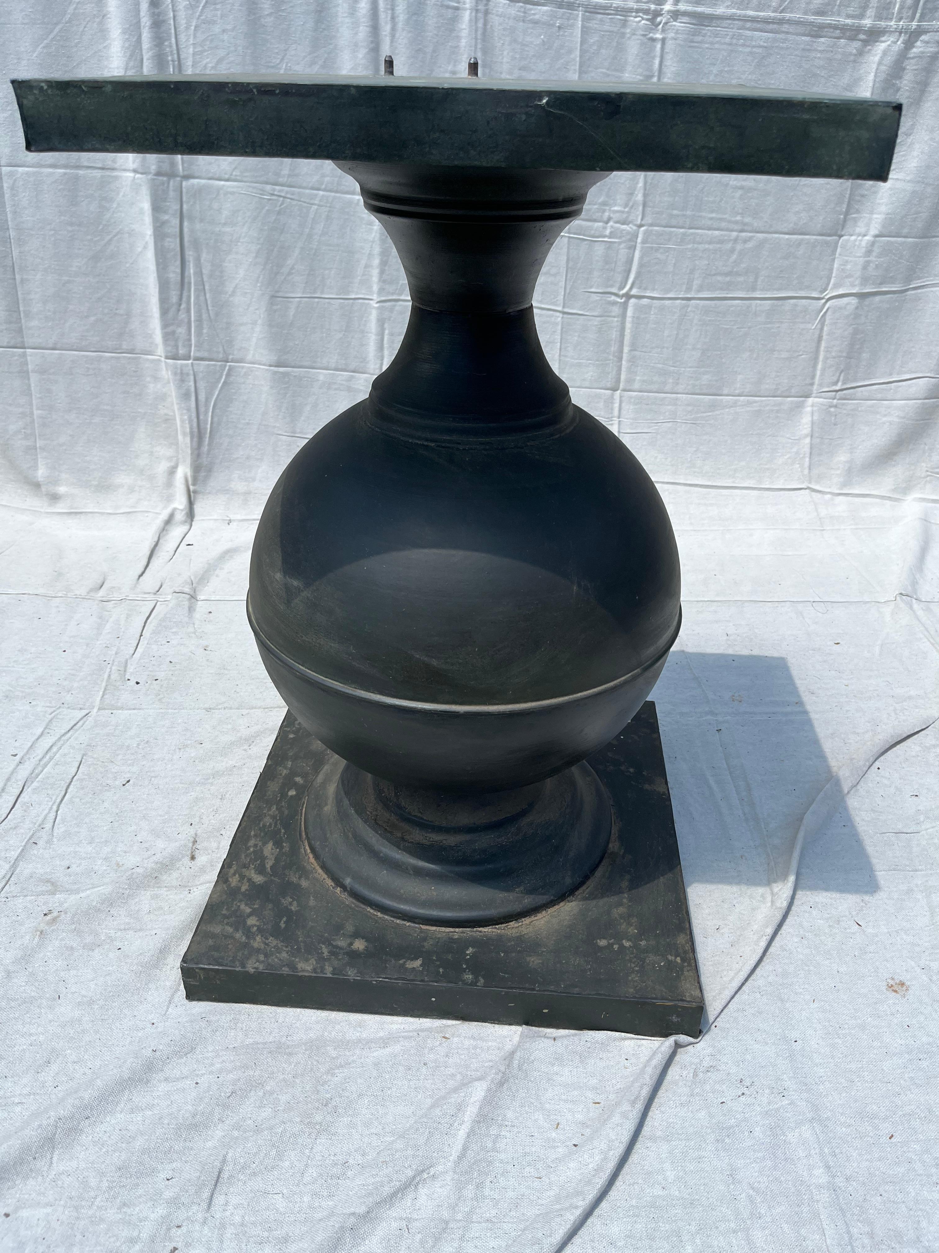 A contemporary round metal pedestal table.

   