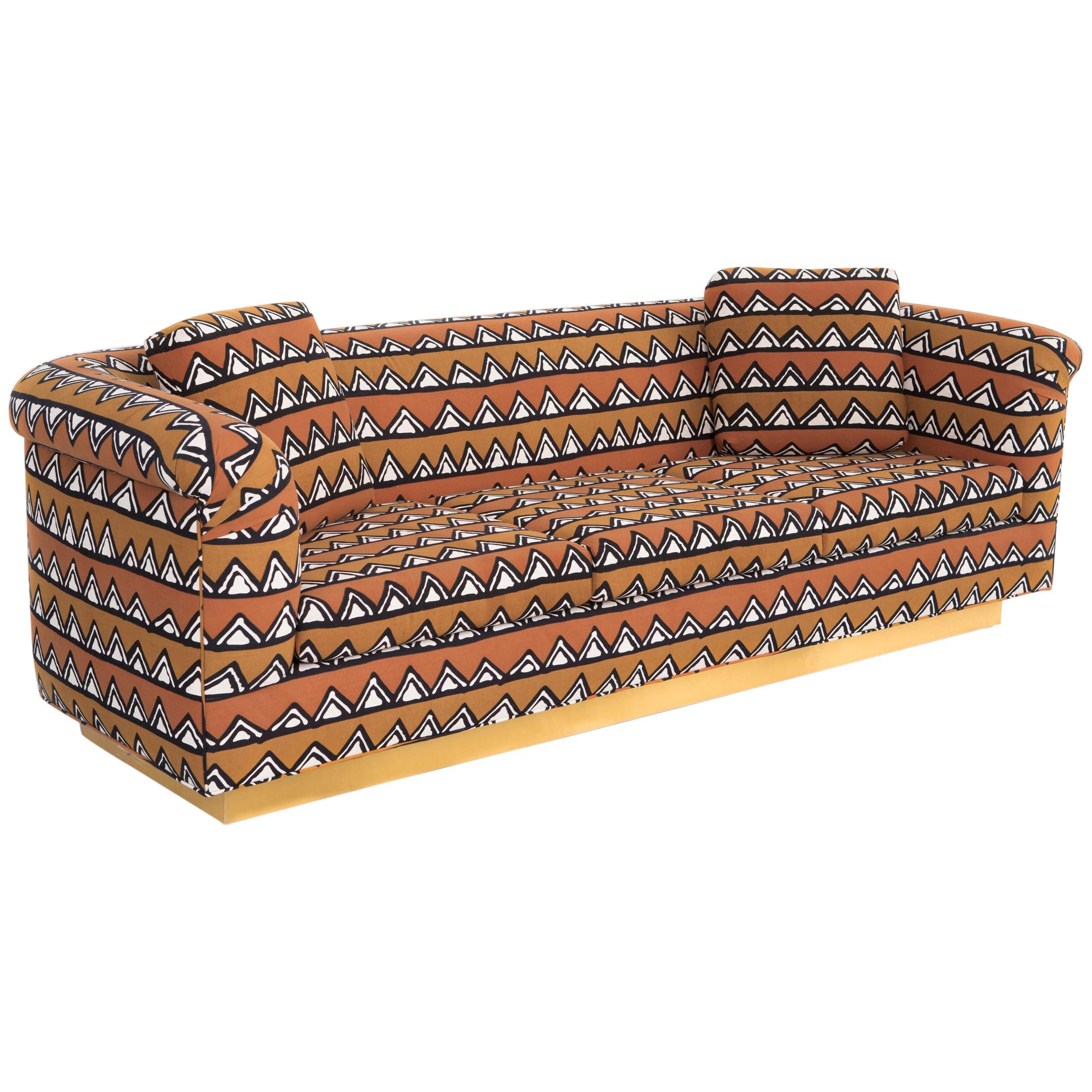 Rounded Barrel Back Brass Platform Sofa Reupholstered in African Mud Cloth For Sale