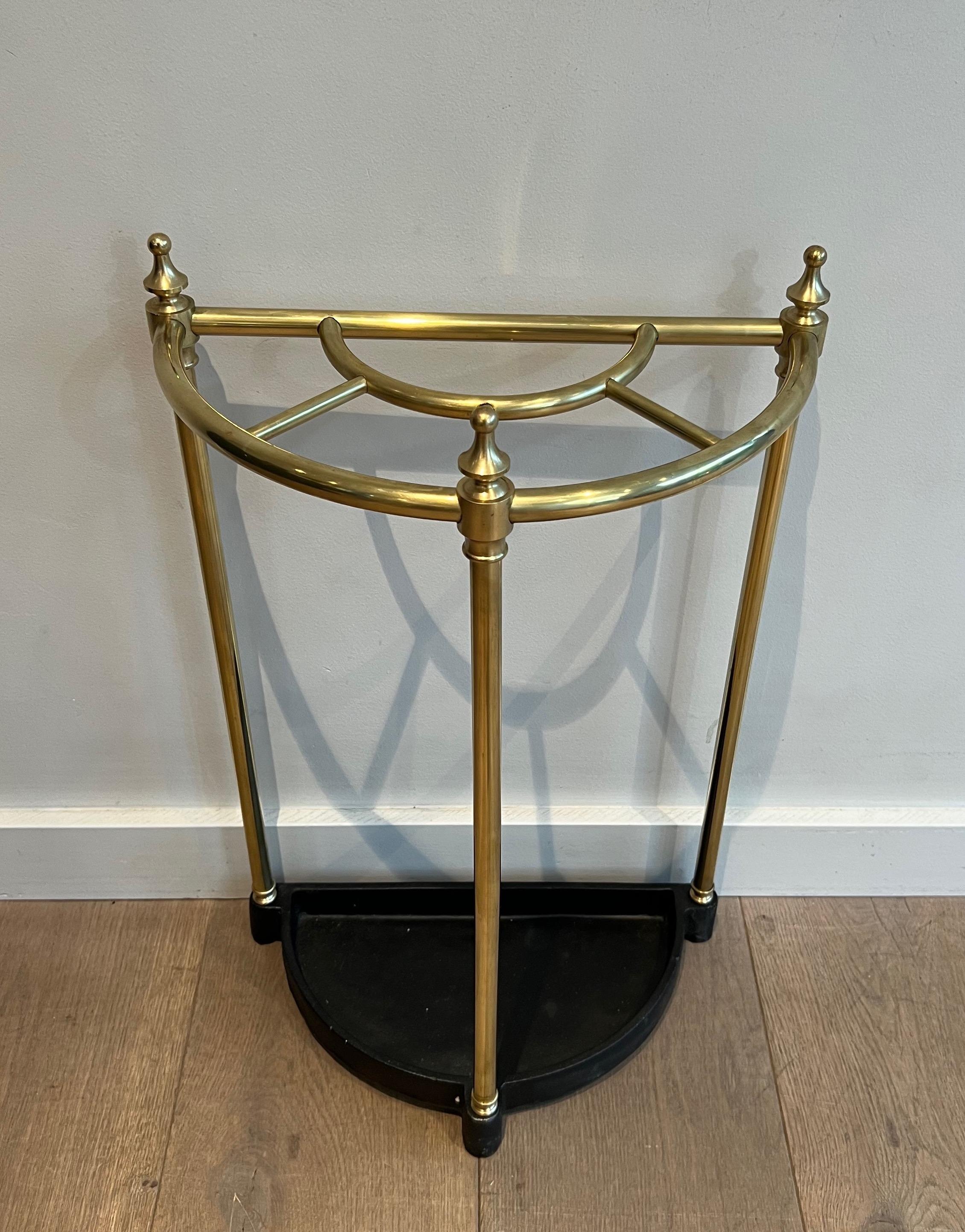 This nice rounded umbrella stand is made of brass and cast iron. This is a French work. Circa 1900