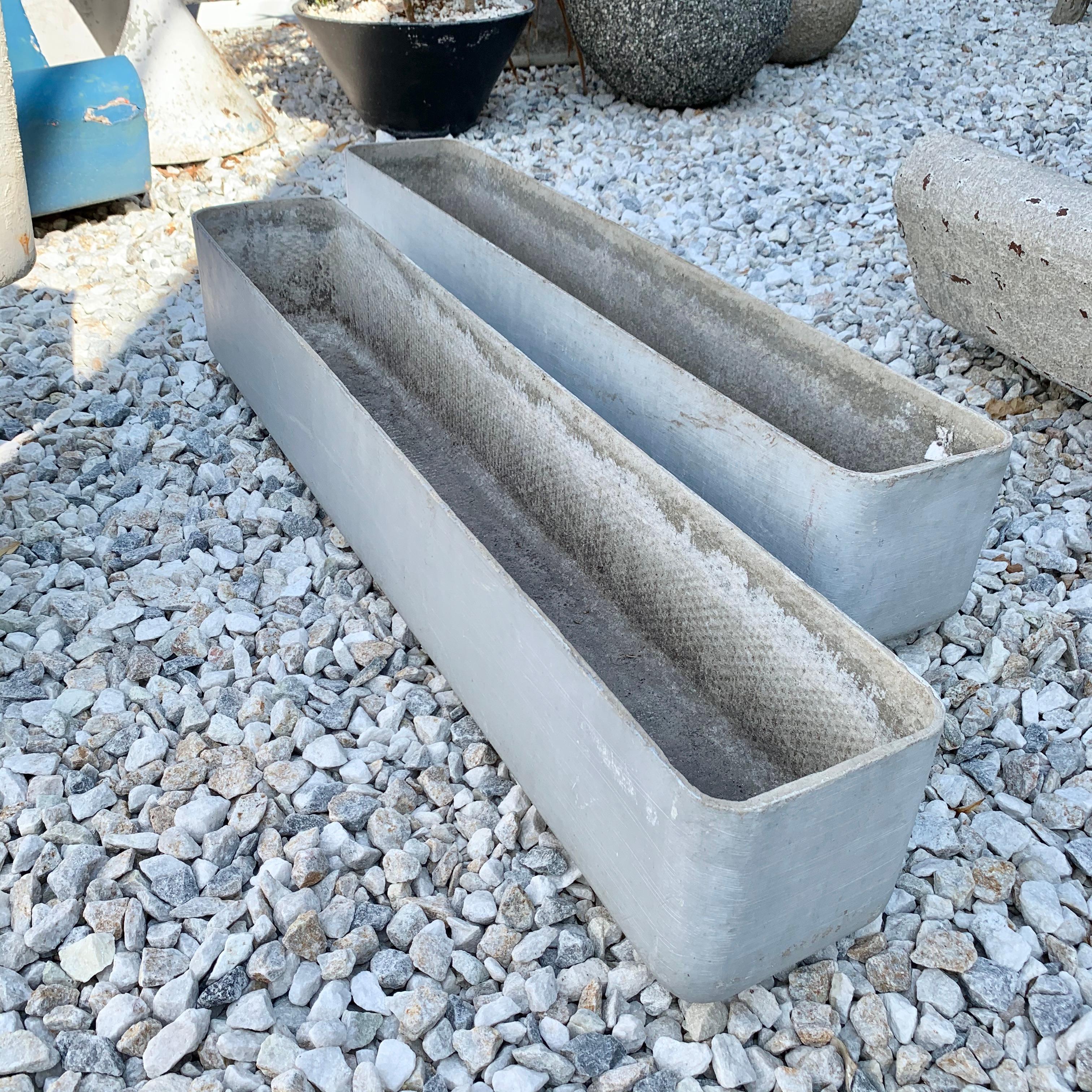 Matching pair of rectangular planter by Swiss architect Willy Guhl for Eternit. Rounded edges throughout. Just under 3.5 feet long. Great lines and clean design. Good vintage condition and patina. Perfect for narrow spaces indoors or outside. 

2