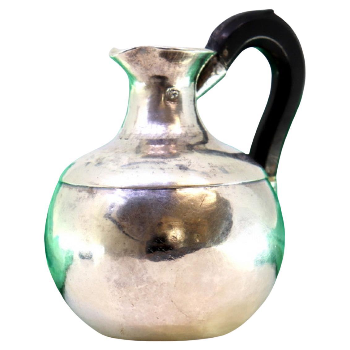 Rounded silver wine jug with chestnut wood handle and half-heart shaped appliqué For Sale