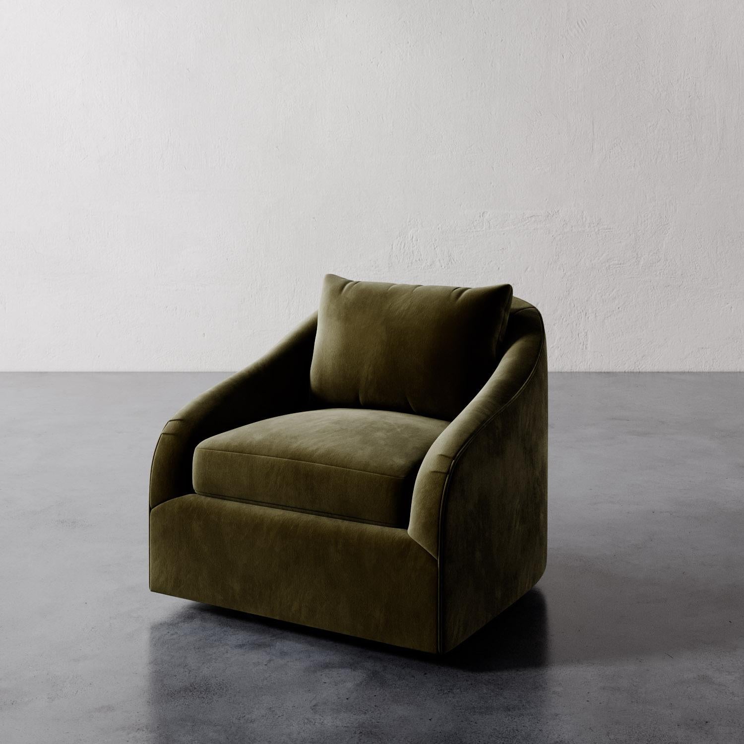 The Rousseau Swivel Chair from Lemieux et Cie is a study in quiet elegance, its graceful lines and sculptural silhouette evoking the refined restraint of 1940s French design. The subtly sloped arms lend a soft curvature, recalling the enveloping