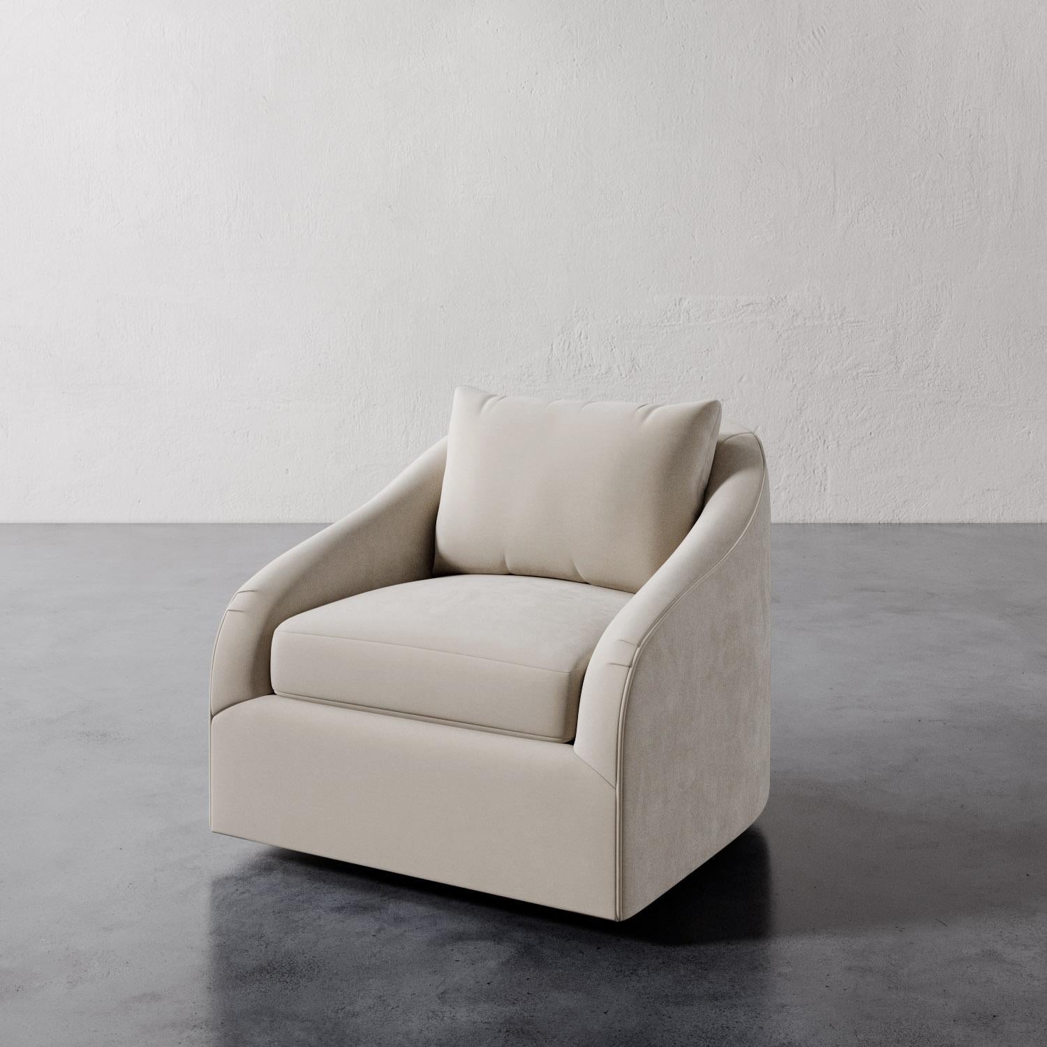 The Rousseau Swivel Chair from Lemieux et Cie is a study in quiet elegance, its graceful lines and sculptural silhouette evoking the refined restraint of 1940s French design. The subtly sloped arms lend a soft curvature, recalling the enveloping
