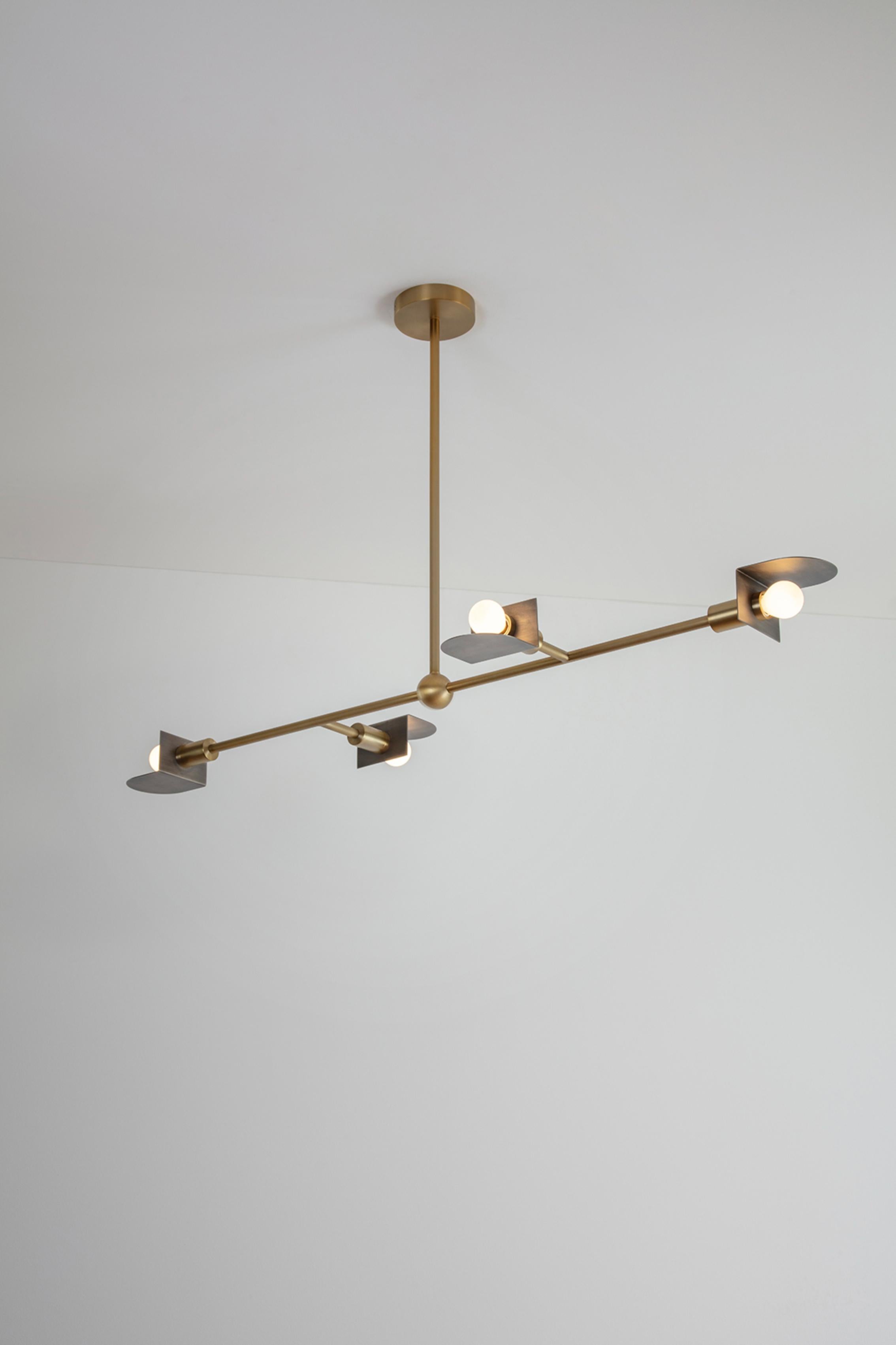 Route I Pendant Light by Square in Circle
Dimensions: D117 x W6 x H63 cm
Materials: Brushed brass/ brushed grey metal
Other finishes available.

An ambitious linear pendant displaying geometric semicircular metal shades with returns. This four-armed