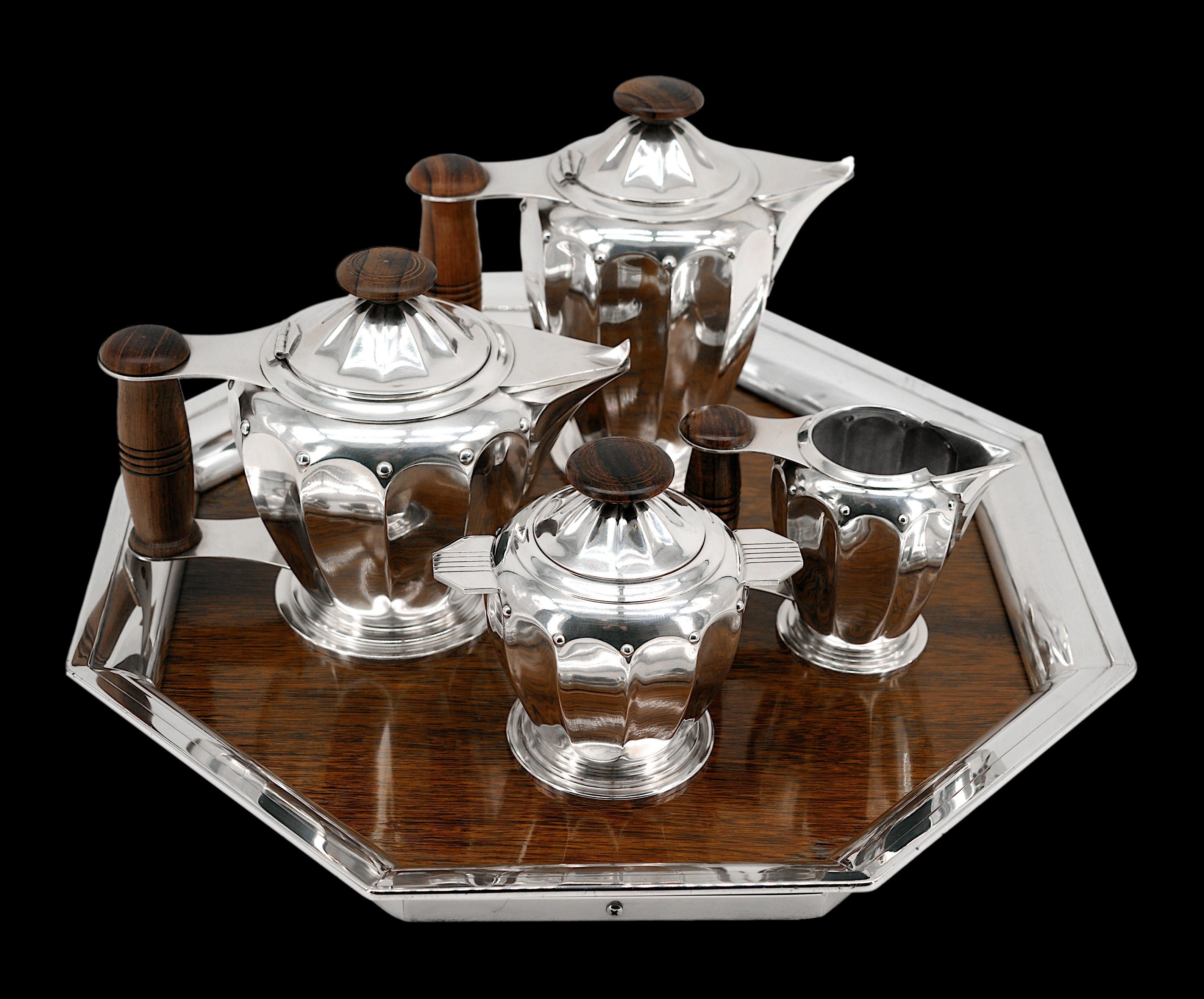 French Art Deco teay / coffee set by ROUX-MARQUIAND (Lyon), France, 1924. Silverplate metal and noble woods. This tea and coffee service obtained a gold medal at the Salon des Arts Décoratifs of 1925, in Paris. It is composed of four pieces, this