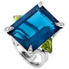 Roxa 18 Karat White Gold 0.08 Carat Diamond, Royal Blue Topaz and Peridot Ring