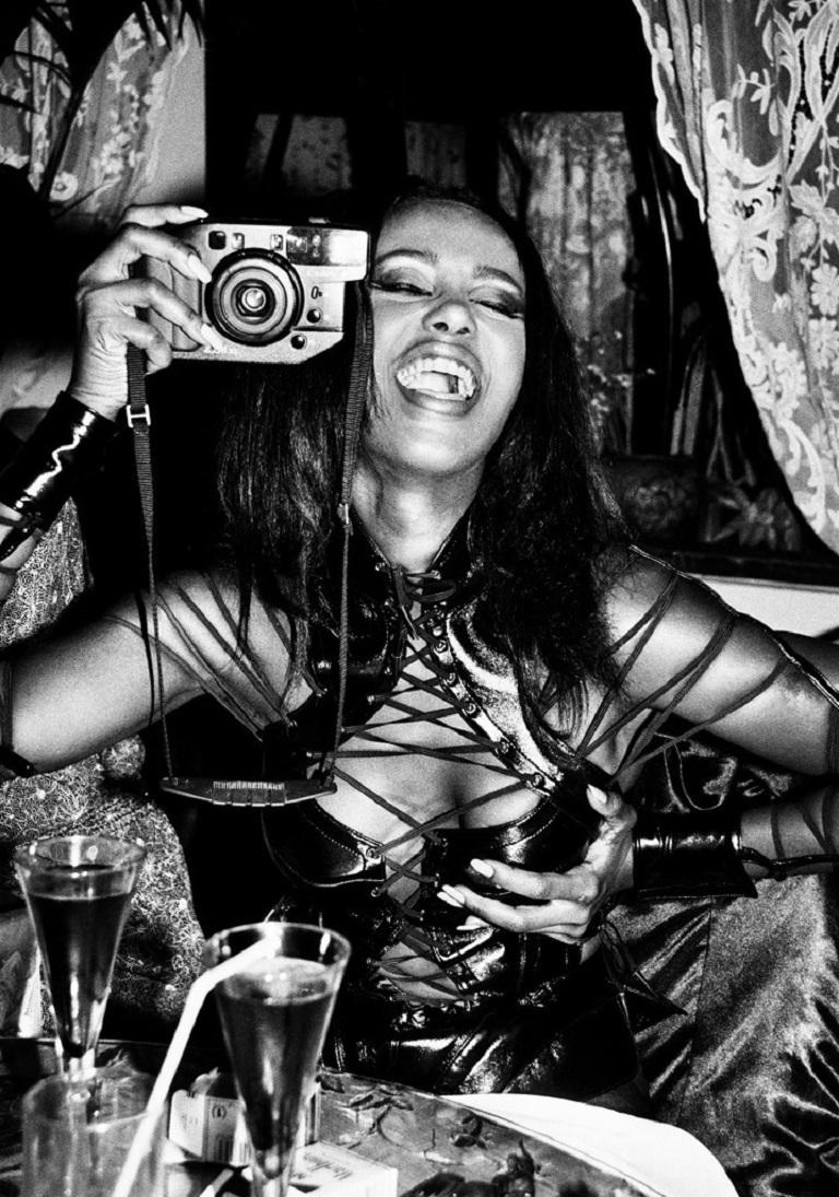 Roxanne Lowit Portrait Photograph - Iman, Paris - black-and-white portrait of model Iman in corsage with camera 